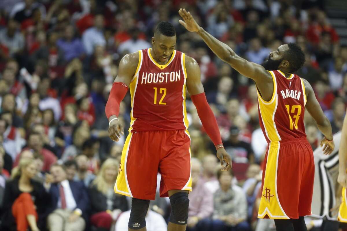 Houston Rockets guard James Harden, right, congratulates center Dwight Howard, after drawing a foul on a shot during the second half of an NBA game at the Toyota Center, Thursday, Nov. 6, 2014, in Houston. (Cody Duty / Houston Chronicle)