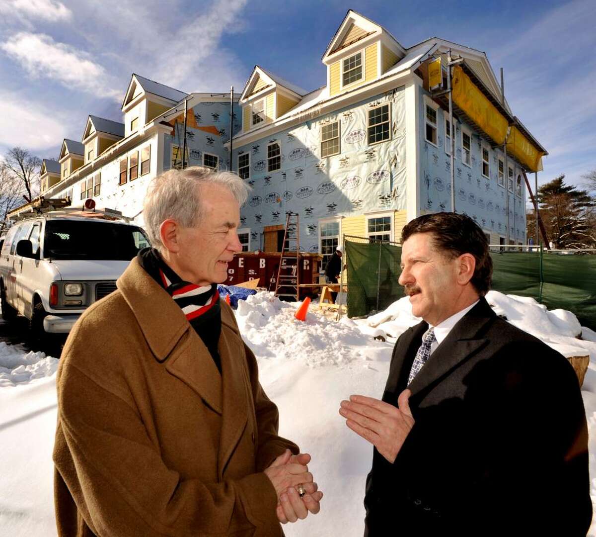 Dr. Irv Jennings, executive director of Childern's and Family Aid talks with Foundation Board member Gene Eriquez, in front of the new facility in Danbury, on Thursday, Feb.18,2010.