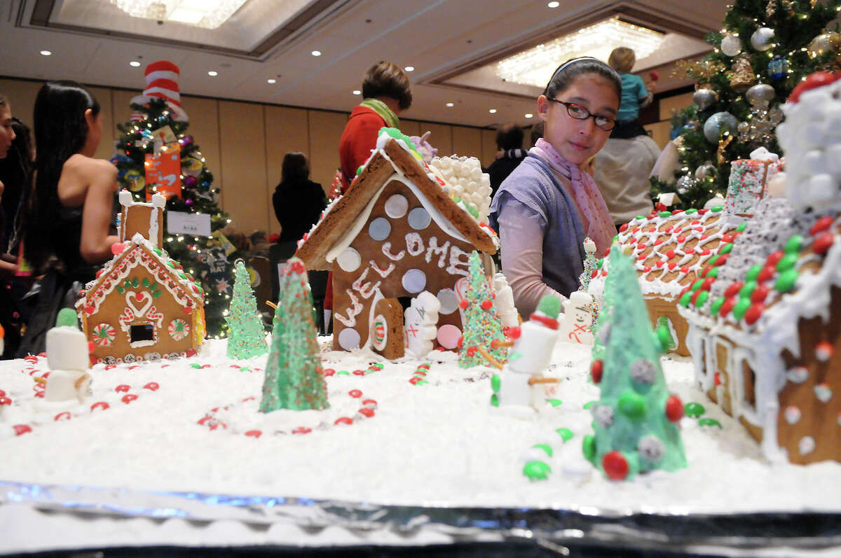 Lucy Connolly eyes the gingerbread creations at the Junior League of Greenwich's Enchanted Forest annual fundraiser at the Hyatt Regency Greenwich in Greenwich, Conn., Nov. 24, 2013. Gingerbread houses have long been a draw for the Junior League of Greenwich's annual Enchanted Forest benefit. The event, and the tasty treats (among other attractions), return Friday, Nov. 21 through Sunday, November 23, 2014, at the Hyatt Regency in Greenwich, Conn.