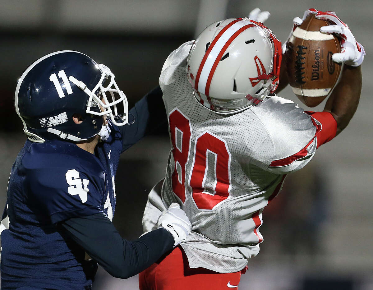 Rocket receiver Michael Akai pulls in a long pass behind Randy Rios as Judson hosts Smithson Valley at Rutledge Stadium on November 7, 2014.