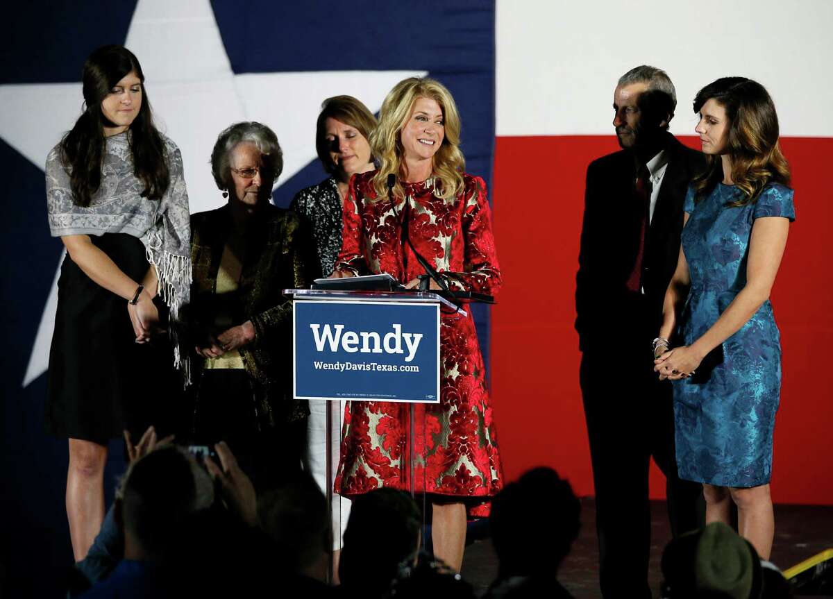 Texas Democratic gubernatorial candidate Wendy Davis makes her concession speech at her election watch party, Tuesday, Nov. 4, 2014, in Fort Worth, Texas. Davis' family, daughter Dru, from left, mother Ginger Russell, sister Jennifer James, brother Joey Russell and daughter Amber, right, watch during the speech. (AP Photo/Tony Gutierrez)