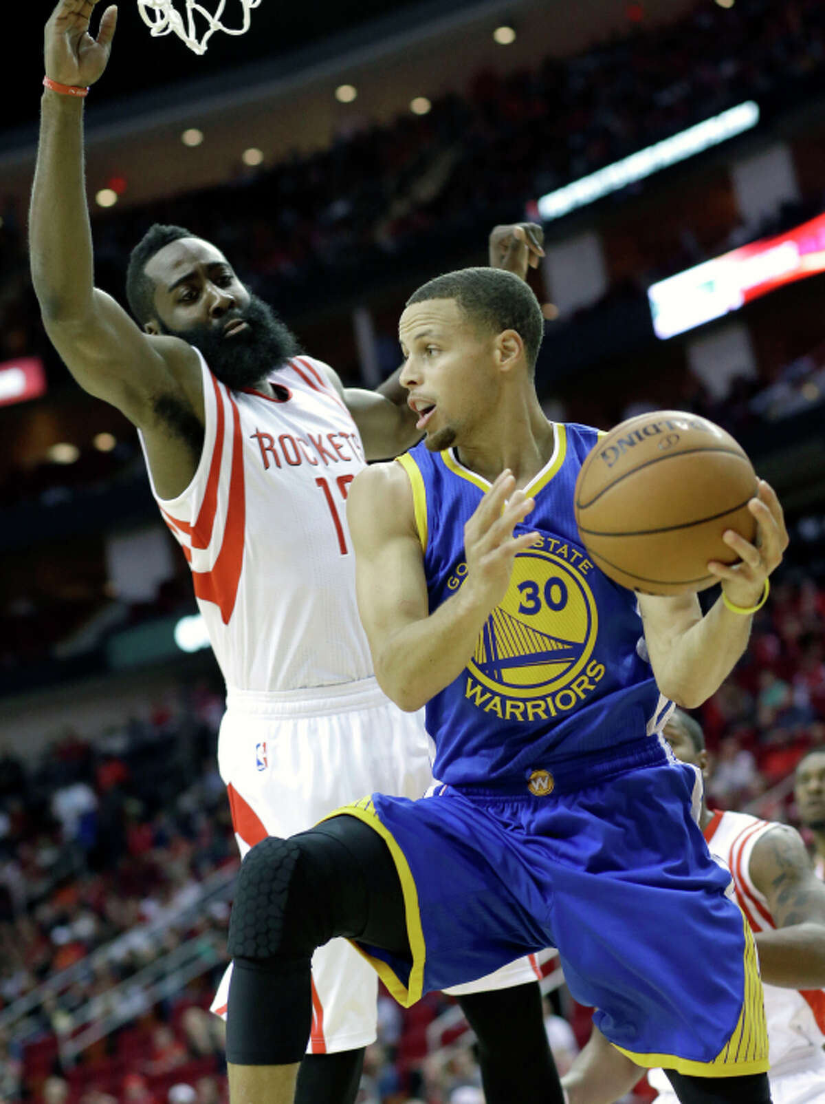 Stephen Curry, who had 34 points, is hounded by James Harden.