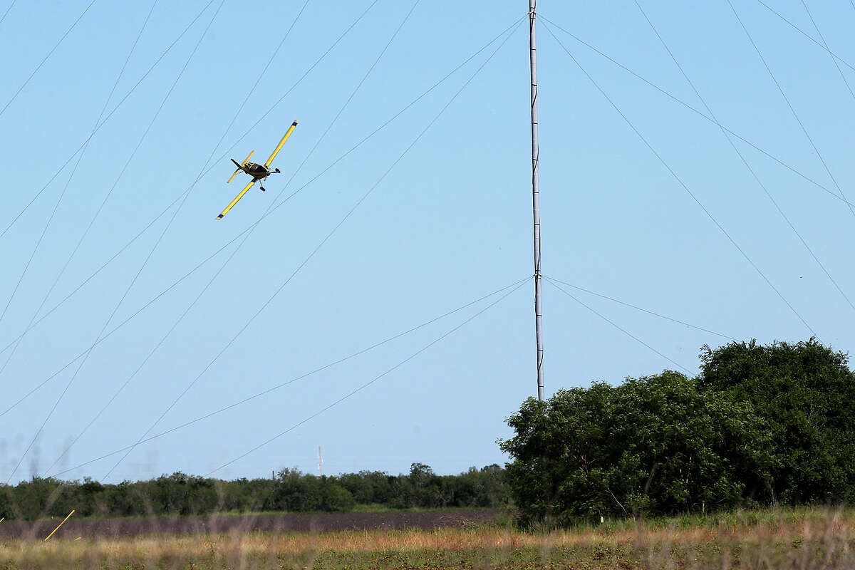 Sun Valley Crop Dusting Company pilot Steve Freeman works a field by a temporary meteorological evaluation tower, (METs), near San Benito, Texas on Thursday, Oct. 16, 2014. Crop dusters are some of the most talented pilots out there, accustomed to maneuvering around the subdivisions increasingly fragmenting once primarily rural areas such as the Rio Grande Valley. But in recent years at least five have died in accidents involving temporary meteorological evaluation towers, or METs, which are to pilots barely visible metal towers used by energy companies to site wind turbines.