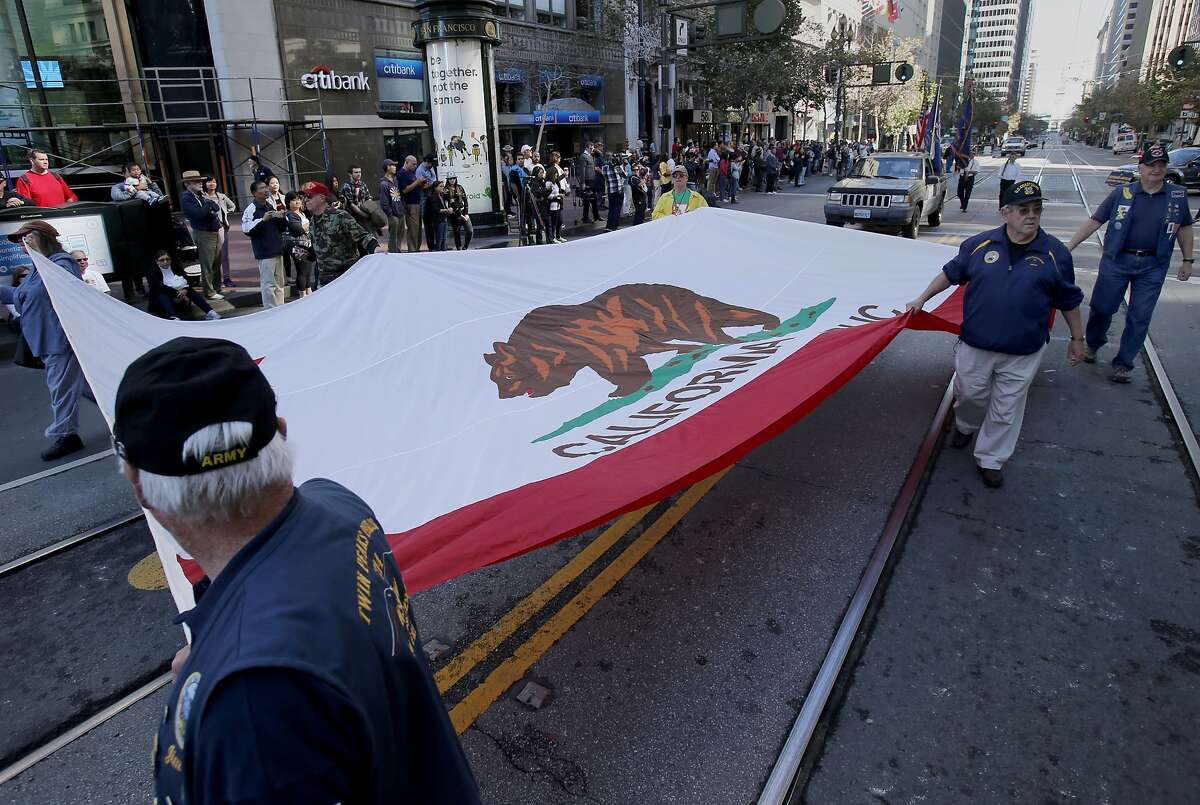 The Native Sons of the Golden West paraded a huge state flag Sunday November 9, 2014. The annual Veterans Day parade was held in San Francisco, Calif on Market Street as hundreds stood and cheered.