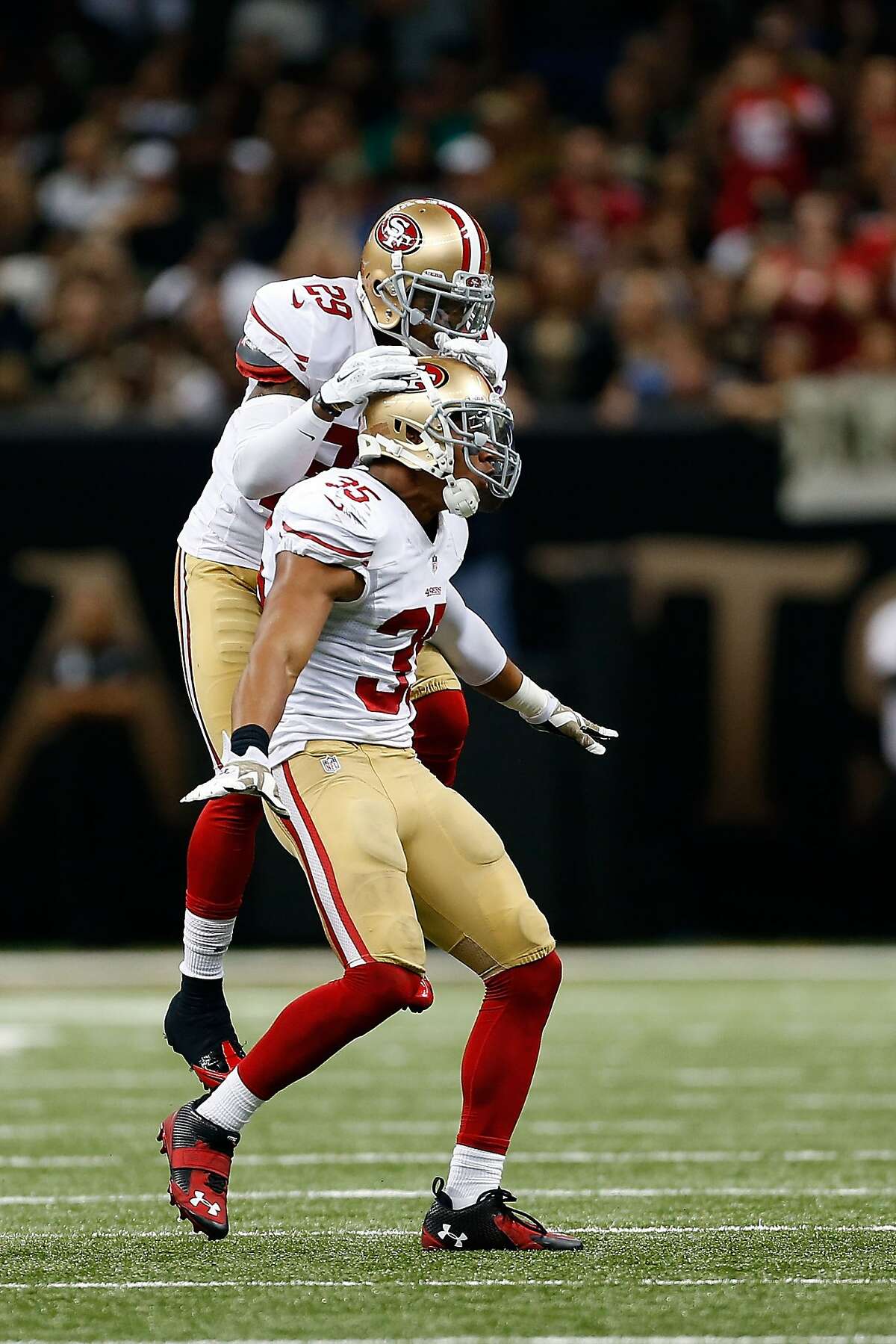NEW ORLEANS, LA - NOVEMBER 09: Eric Reid #35 of the San Francisco 49ers is conratulated by Chris Culliver #29 following a defensive stop during the fourth quarter of a game against the New Orleans Saints at the Mercedes-Benz Superdome on November 9, 2014 in New Orleans, Louisiana. (Photo by Wesley Hitt/Getty Images)