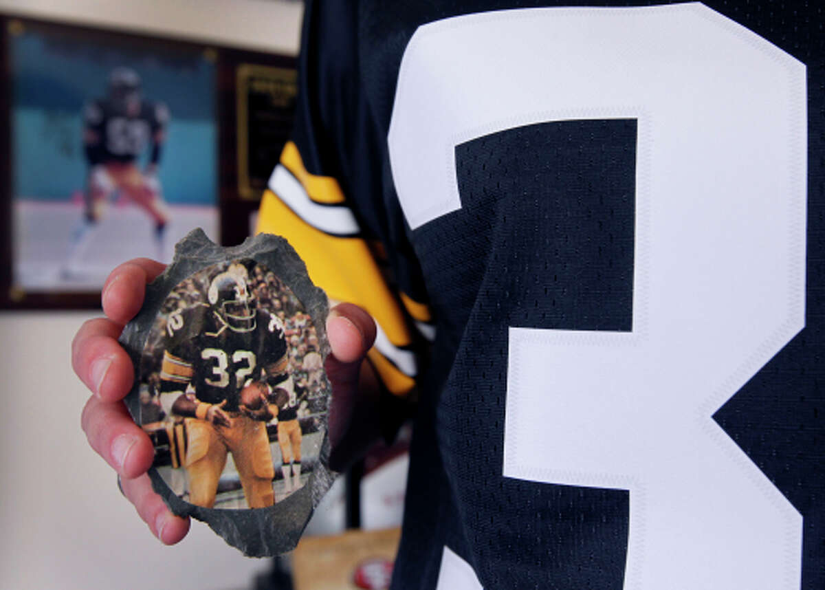 Dawn Ackerman holds a childhood memento of Pittsburgh Steelers legend Franco Harrris in San Francisco. Ackerman, a lifelong Steelers fan and president of Out Smart Office Solutions, will be making a bid to provide office design and supplies for Super Bowl 50, which for the first time in its history, the NFL is inviting LGBT-owned companies to openly participate in.