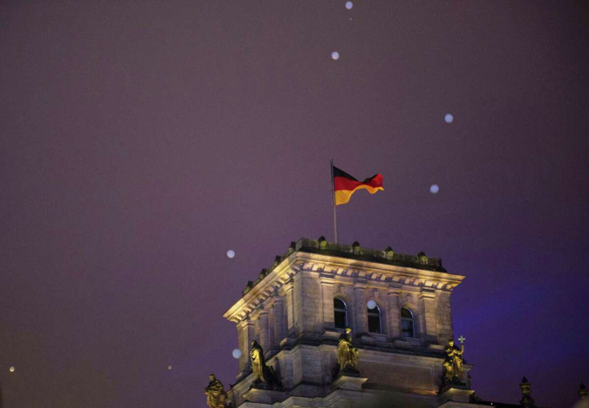Balloons fly over the Reichstag during the central event to commemorate the Fall of the Wall in Berlin, Germany, Sunday, Nov. 9, 2014. 25 years ago - on Nov. 9, 1989 - the East-German government lifted travel restrictions and thousands of East Berliners had pushed their way past perplexed border guards to celebrate freedom with their brethren in the West. (AP Photo/Steffi Loos)