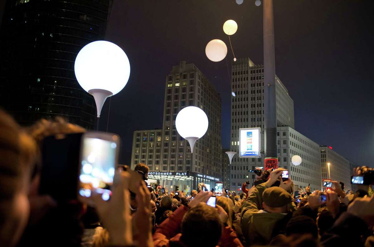 Balloons of the art installation "Lichtgrenze 2014" fly away at Potsdamer Platz to com-memorate the 25th anniversary of the Nov. 9, 1989 fall of the Berlin Wall ﻿on Sunday﻿.﻿ "For peace and freedom," said mayor Klaus Wowereit.