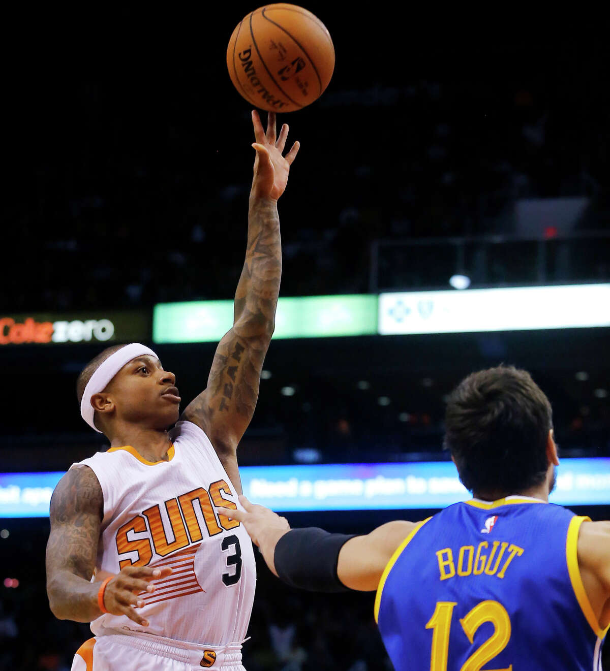 Suns guard Isaiah Thomas shoots over Warriors center Andrew Bogut during the second half. He scored 15 points in the fourth quarter as Phoenix rallied to win.