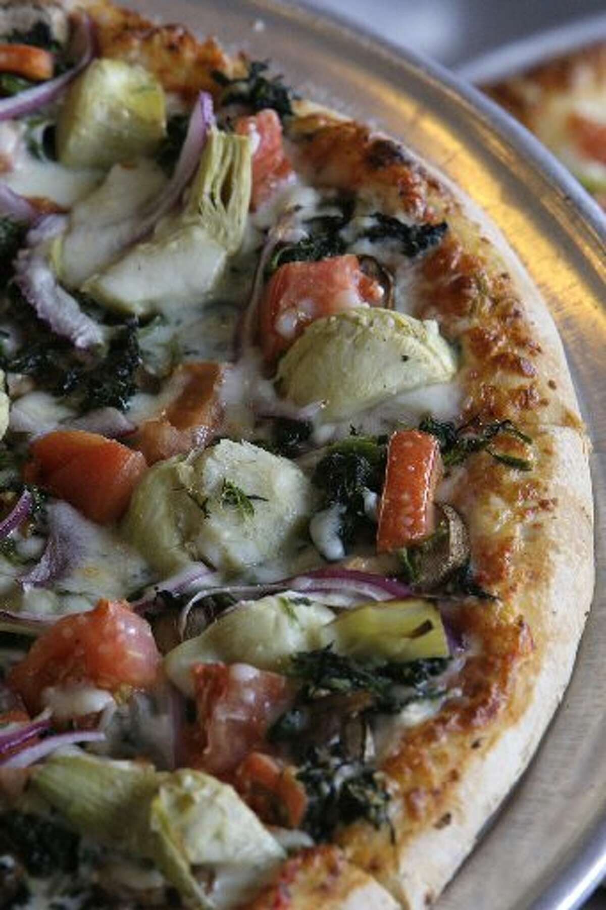Rome's Pizza Vegetarian Deluxe come with Mozzarella, spinach, mushrooms, artichoke hearts, tomatoes and red onions.