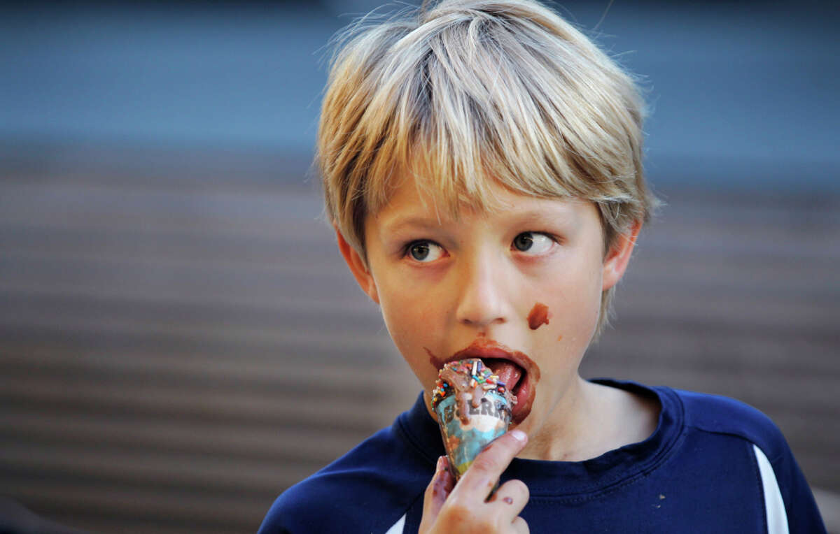 Errol Hecht, 10, enjoys the last of his ice cream cone while hanging out outside the Haight Street Market on Nov. 8, 2014, in San Francisco.