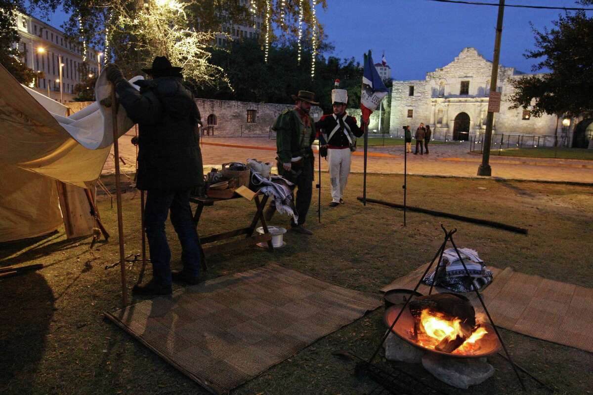 Members of the San Antonio Living History Association Nathan Weiss (from left), Grant Maloney and Adam Dominguez set up camp in Alamo Plaza on Dec. 6, 2013. The group reenacted the Battle of Bejar the next day.