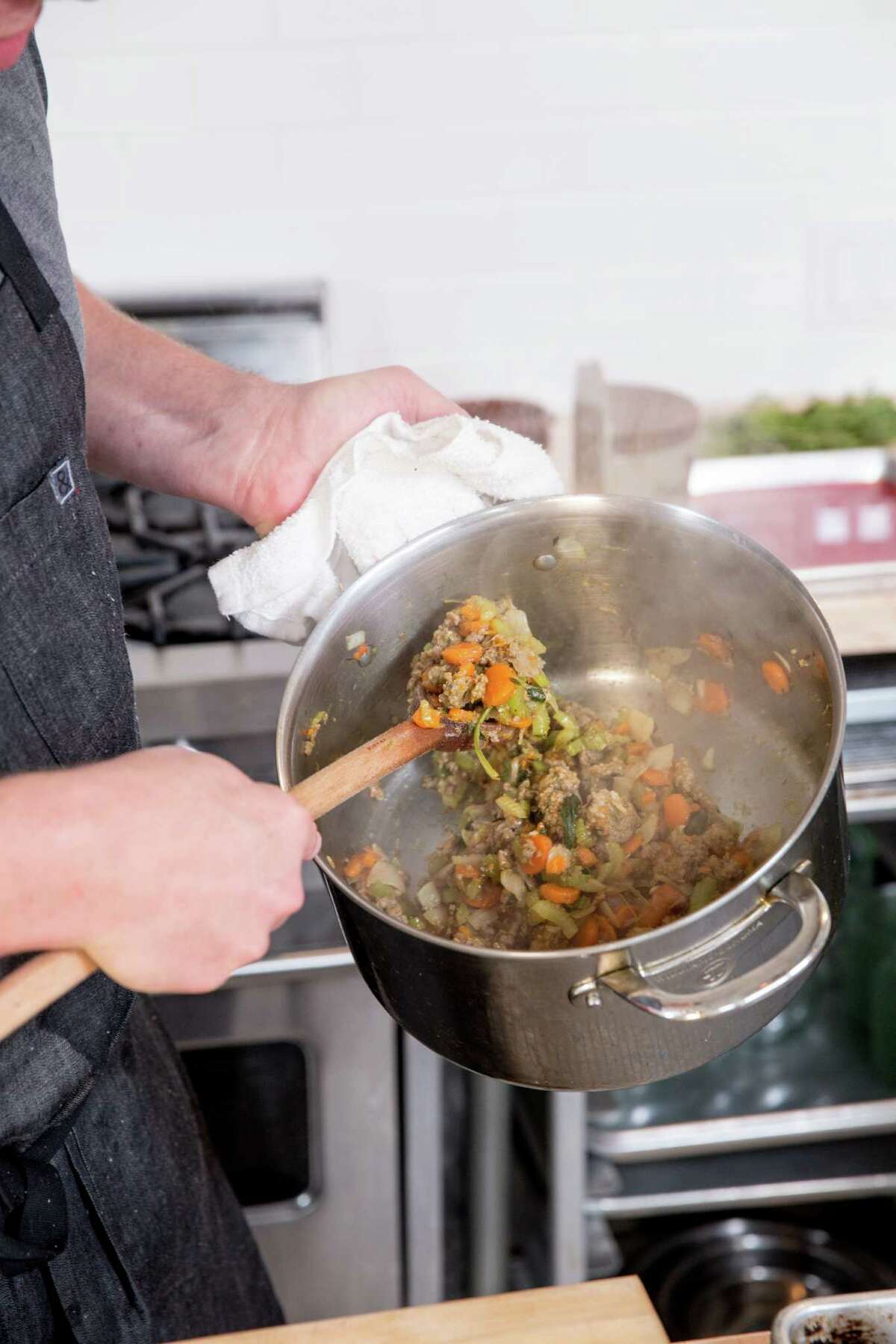 Tyler Florence stirs the sausage, vegetables and herbs that he will use to make stuffing.