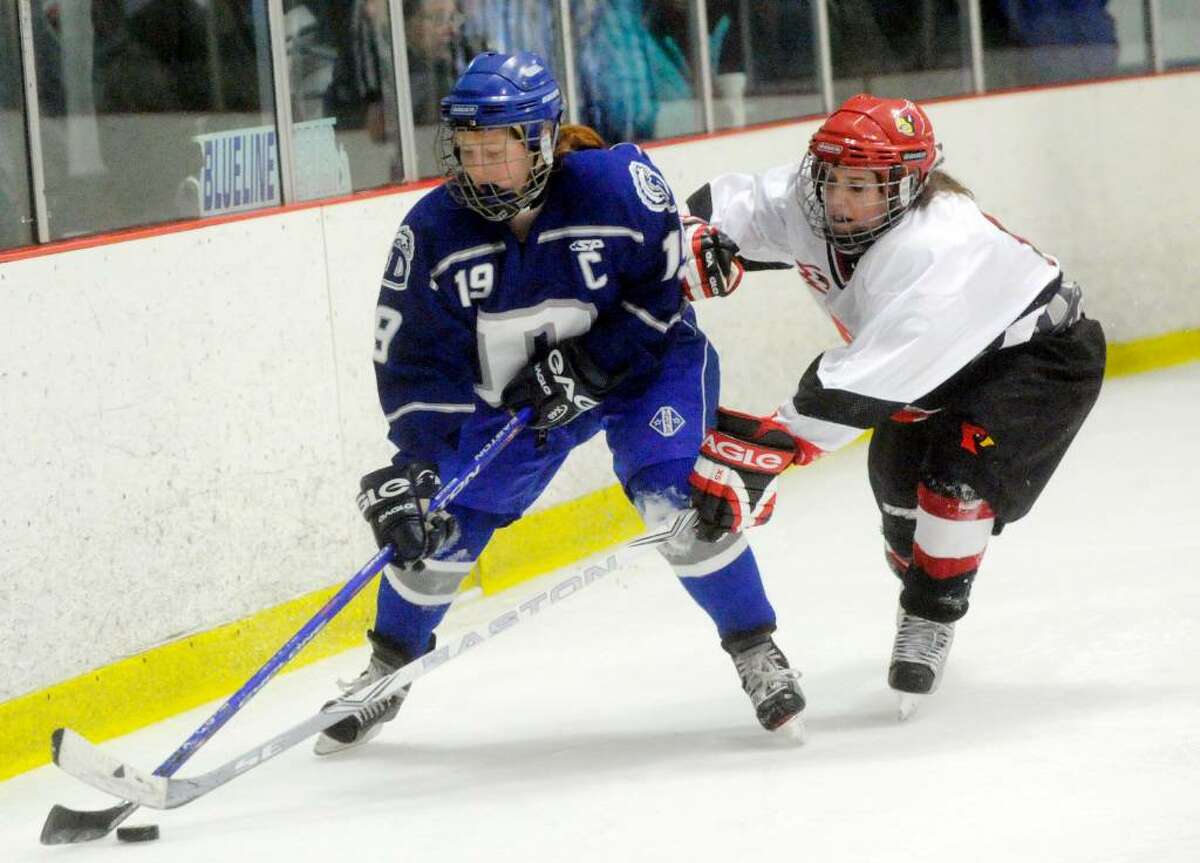 Greenwich's Meghan Spezzano closes in on Darien's Madeline Coburn as Darien hosts Greenwich High in a girls hockey game at the Darien Ice Rink Wednesday evening, Feb. 24, 2010.