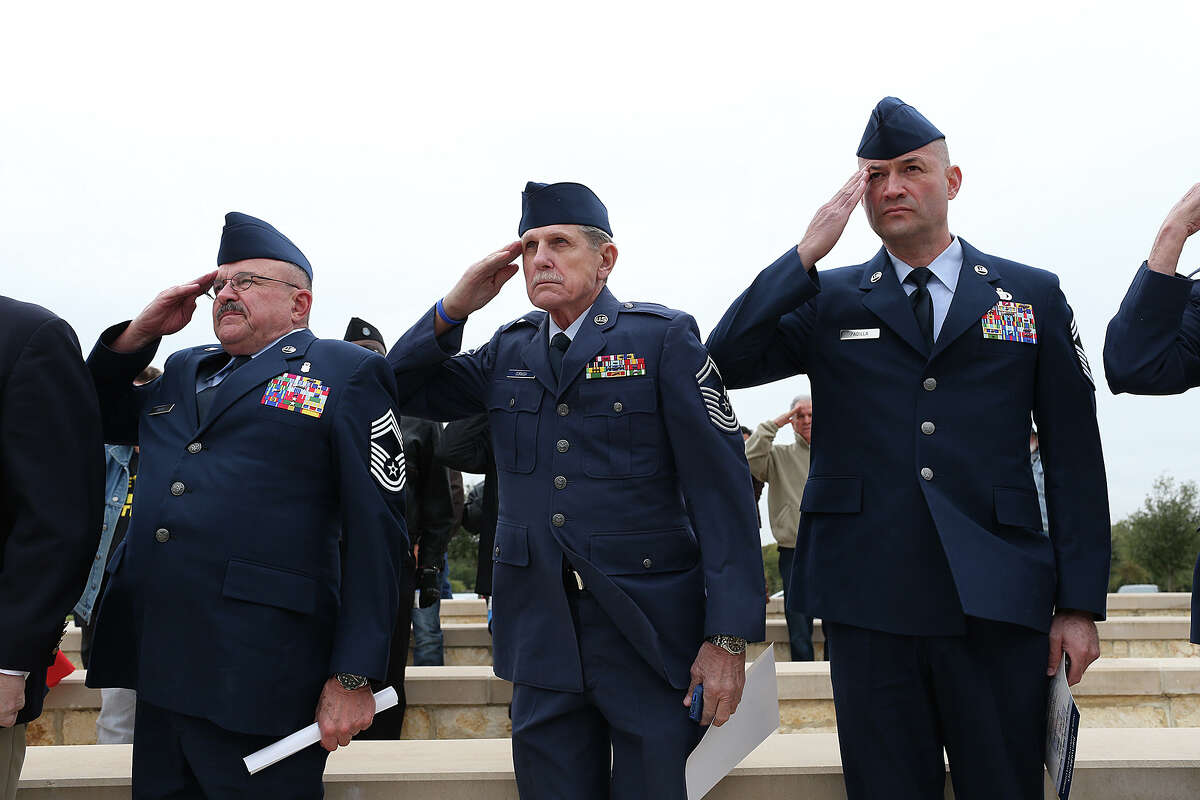 From left, retired Chief Master Sgt. Thomas Hilla, retired Chief Master Sgt. Wendell Cornish and Chief Master Sgt. Pete Padilla salute during a Veteran's Day tribute at Fort Sam Houston National Cemetery, Tuesday, Nov. 11, 2014.