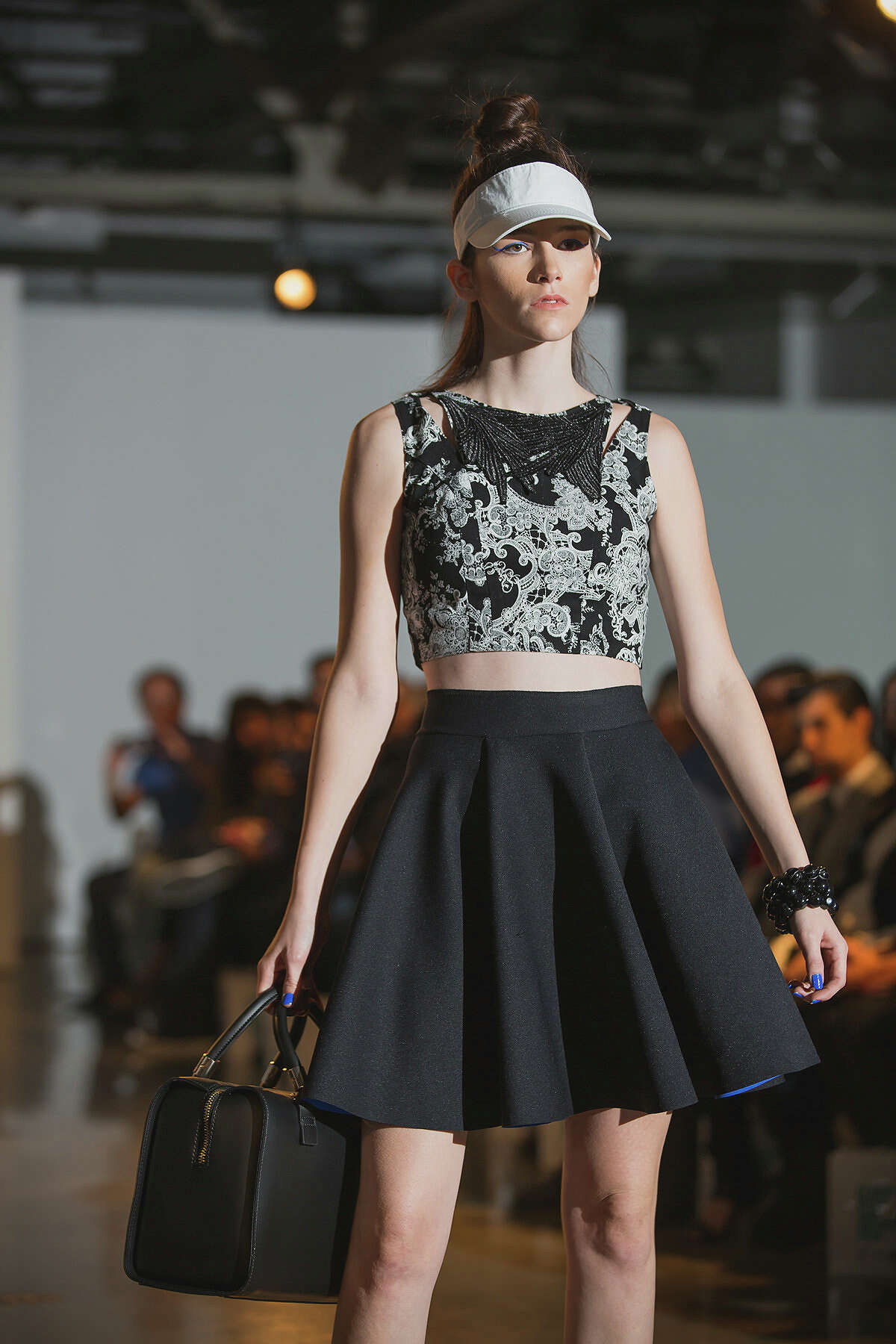 Here's a look from Samantha Plasencia's spring 2015 collection shown during Fashion Week San Antonio. The "Project Runway" contestant and University of the Incarnate Word grad sent out black and white collection with pops of bright cobalt blue in mesh, cotton and neoprene. Many of the separates referenced fashion's current athleisure trend but she also produced beautiful and edgy boxy baby doll dresses, full skirts, on-trend crop tops and fitted trousers, all very wearable.