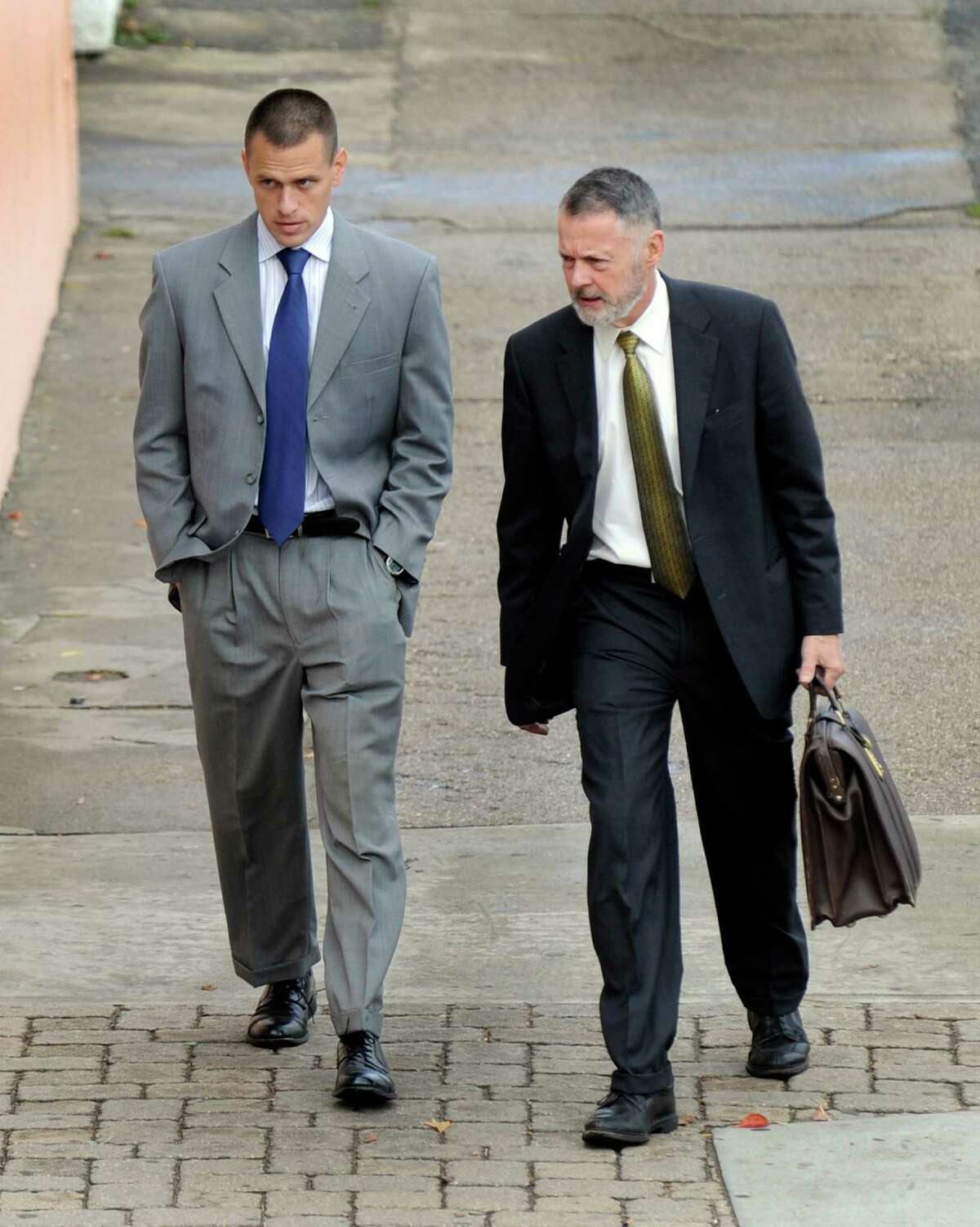 Kyle Seitz, left, arrives at the Danbury Superior Court Wednesday morning, Nov. 12, 2014, accompanied by his attorney. Seitz of Ridgefield, has been charged with negligent homicide in the death of his 15-month-old son Benjamin who died after being left in a hot car.