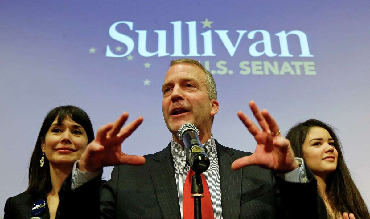 Republican Senate candidate Dan Sullivan, flanked by wife Julie and daughter Meghan, greets supporters on election night in Anchorage, Alaska, last week. Sullivan claimed victory over incumbent Democratic Sen. Mark Begich, D-Alaska, who refused to concede.
