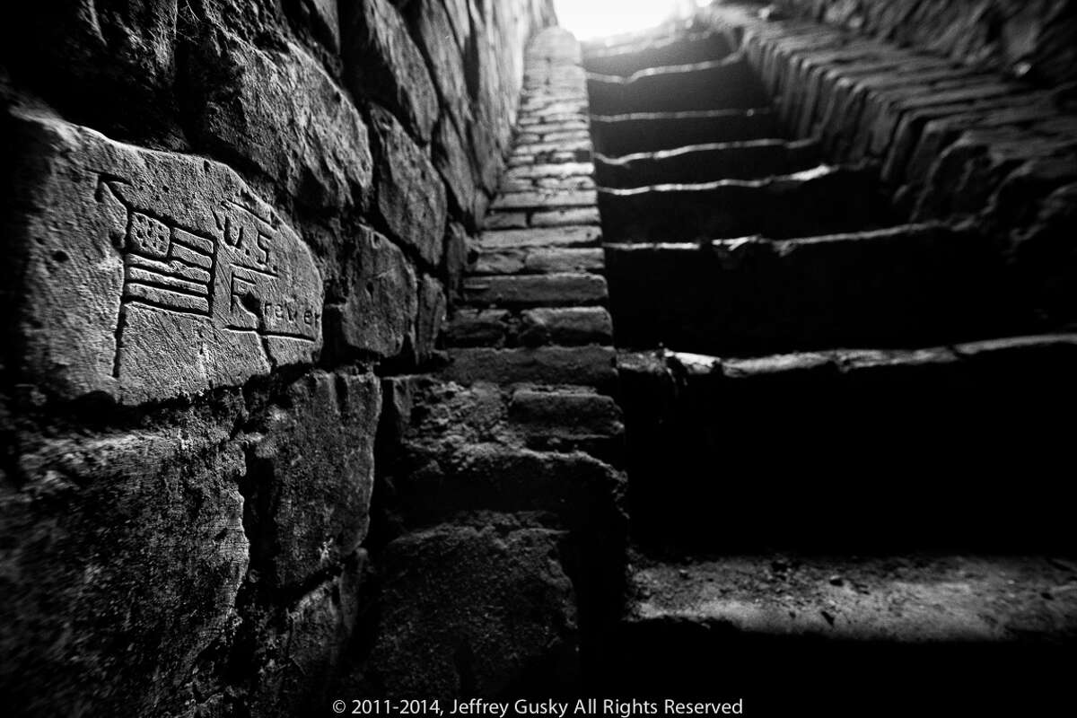 These carvings were done by American soldiers living in underground cities during WW1. Many left messages for loved ones, carved faces and even naked women. French, German and other nationalities also used the converted quarries to survive in, under the treches of France's western front line.