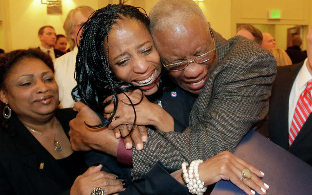 Republican Mia Love (center) celebrates with her father, Jean Maxime Bourdeau, after winning the race in Utah.'s 4th Congressional District during a GOP election night watch party, Tuesday, Nov. 4, 2014, in Salt Lake City. (AP Photo/Rick Bowmer)