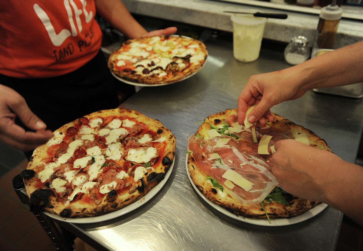 A variety of Neapolitan pizzas are readied to be served at Brick + Wood restaurant in this November 2014 file photo.