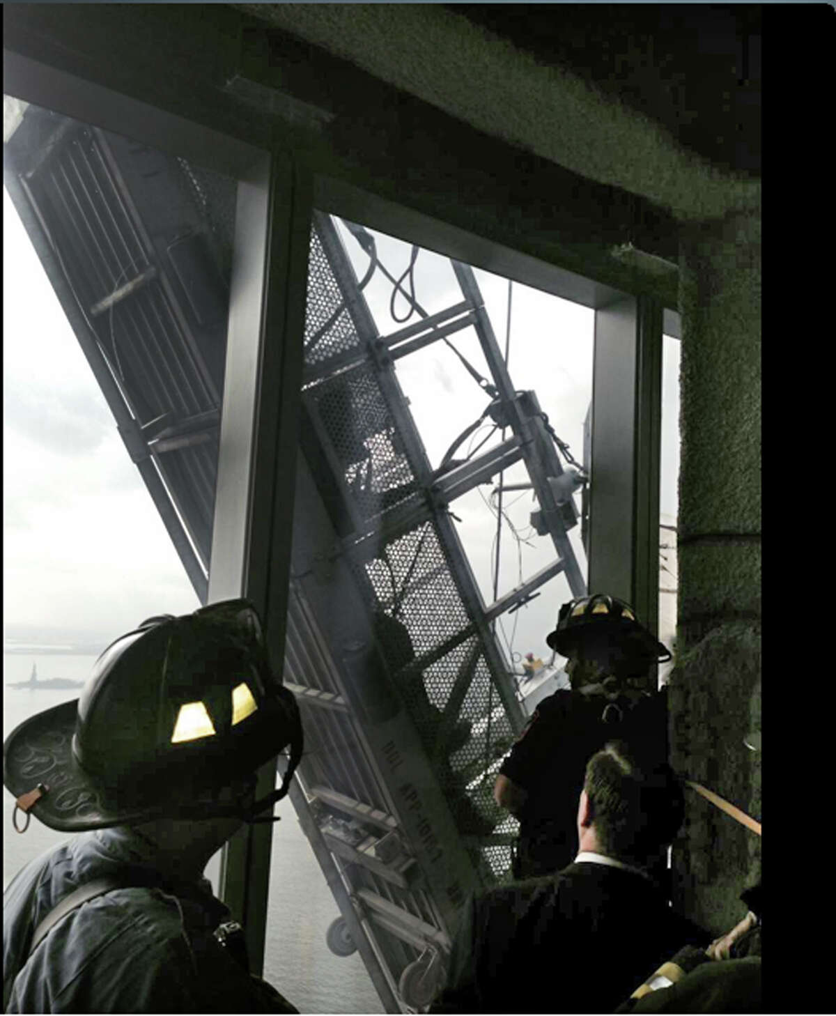 This photo, from the Fire Dept. of New York Twitter page, shows a window washer's gondola as it hangs from 1 World Trade Center. ﻿