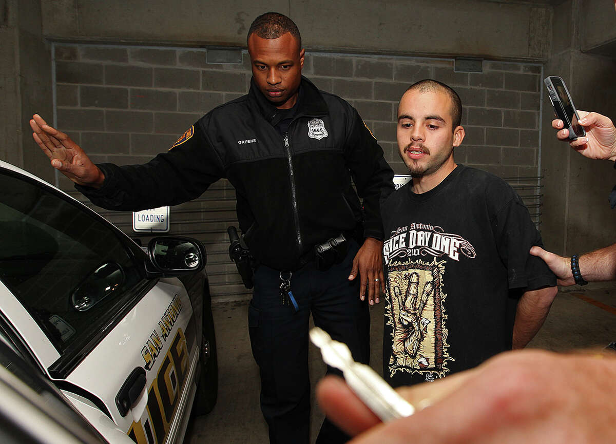 Zachary Gonzales is escorted out of San Antonio Police Deapartment Headquarters, Wednesday, Nov. 12, 2014. Gonzales was arrested earlier in the day on murder charges stemming from Tuesday's VIA bus shooting of Donovan Rae Arzola, 23. He was shot while riding the bus near downtown.