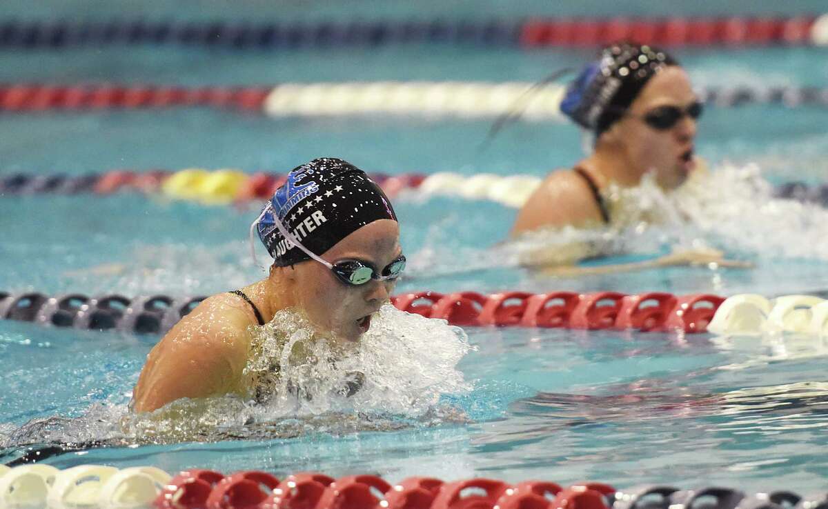 Darien's Phoebe Slaughter, left, and teammate Courtney Ferreira compete in the 200 yard IM at the CIAC Class L girls swimming championship at Southern Connecticut State University in New Haven, Conn. Wednesday, Nov. 12, 2014. Ferreira finished third and Slaughter finished fourth in the event and Darien won the overall competition.