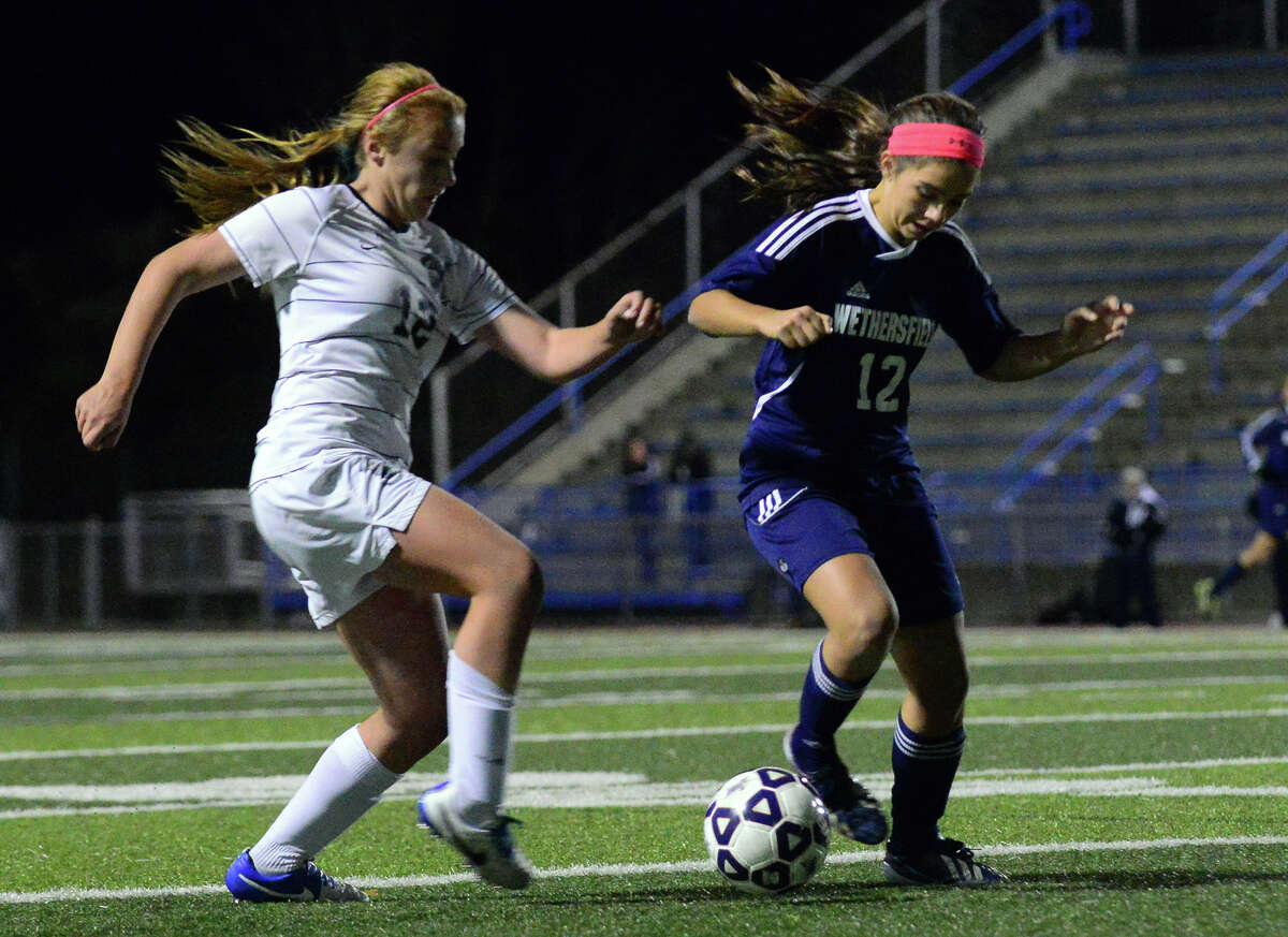 Immaculate's Kayla Lanza, left, and Wethersfield's Nicole Diloreto, during Class L girls soccer semifinal action in West Haven, Conn. on Wednesday Nov. 12, 2014.