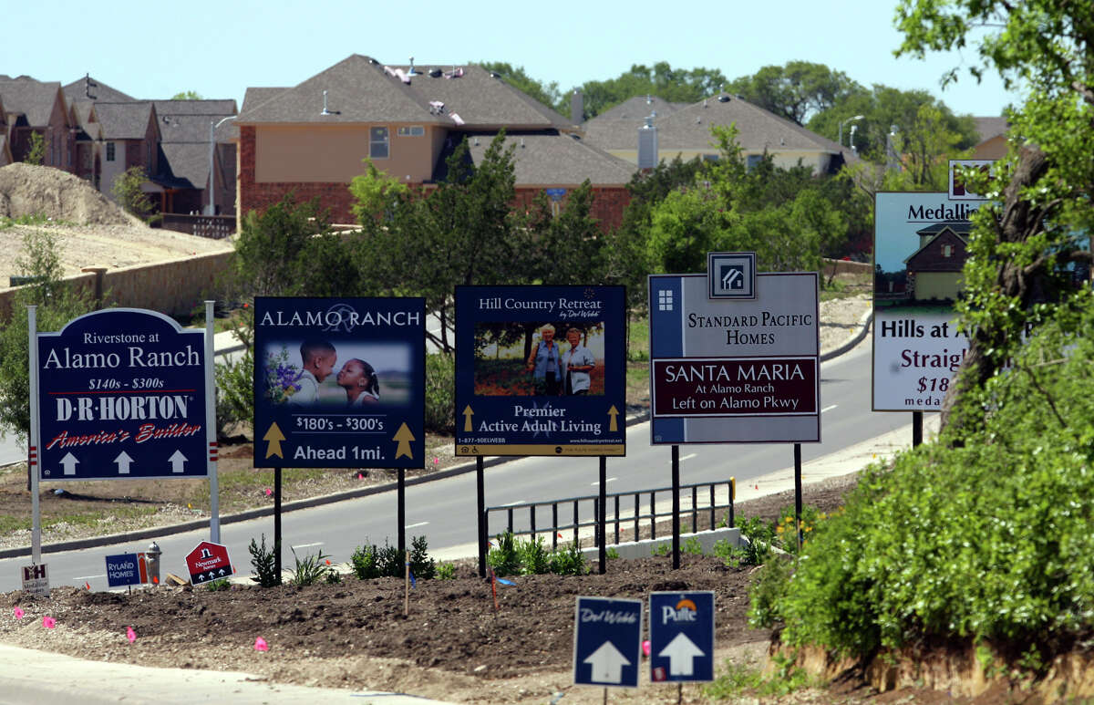 An array of builders' signs greet residents and visitors to the newly constructed Alamo Ranch subdivision in northwest Bexar County. Growth in the area is exploding because of available land and no aquifer restrictions. JOHN DAVENPORT / STAFF