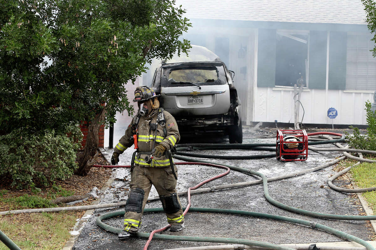 San Antonio firefighters battle a house fire Thursday November 13, 2014 on the 7200 block of Westboro. The cause of the blaze is being investigated and there were no apparent injuries. A car also burned in the blaze.