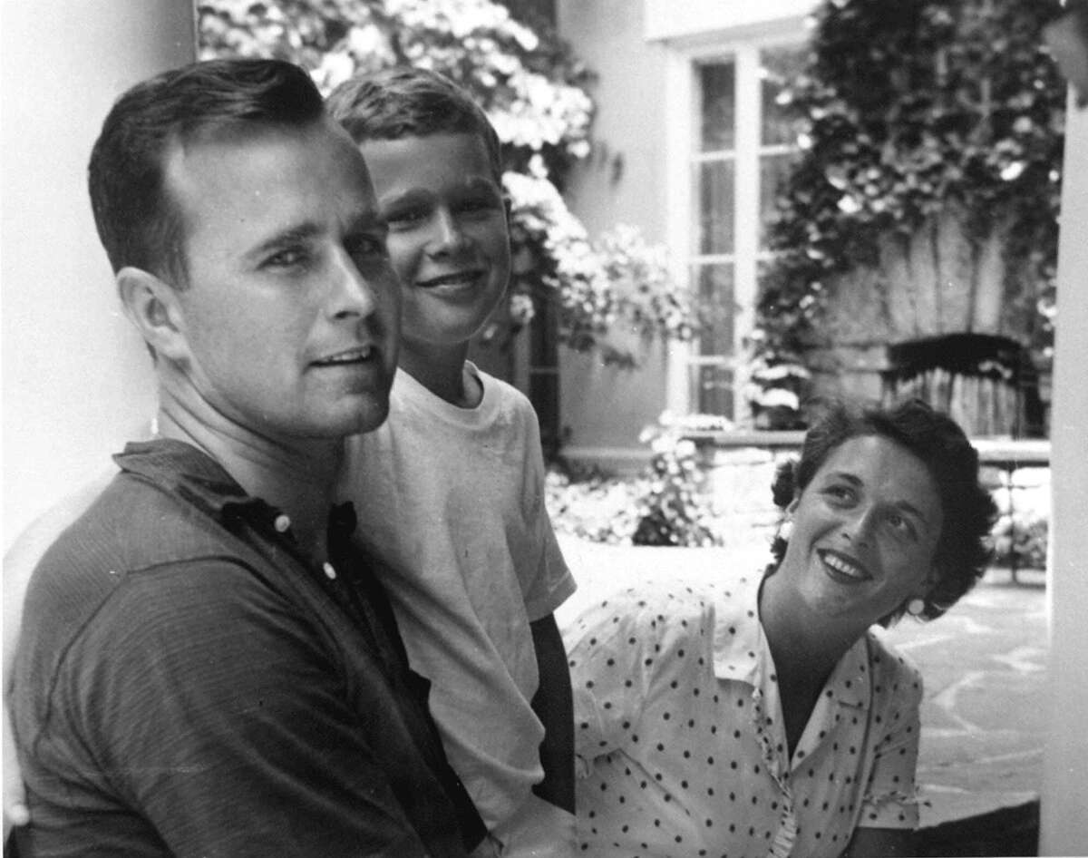 George W. Bush, center, poses with his father George Bush and mother Barbara Bush in Rye, New York, during the summer of 1955. George W. Bush was born July 6, 1946 in New Haven, Conn. (AP Photo/George Bush Presidential Library)
