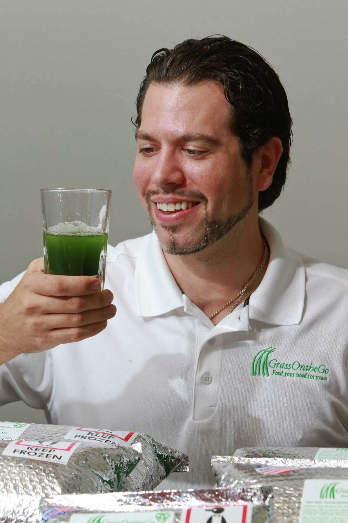 Owner and founder Alan Barrera of GrassOntheGo, with his daily shot of wheatgrass. (For the Chronicle/Gary Fountain, November 11, 2014)