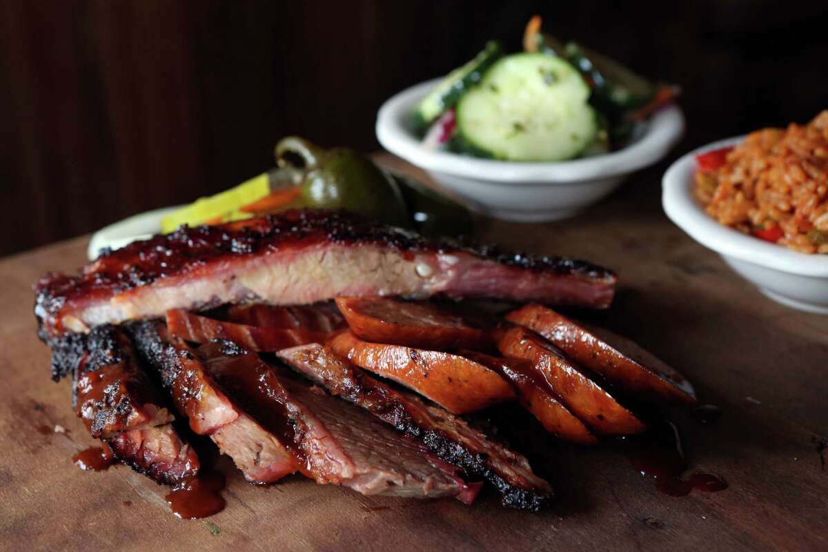 House Special includes pork ribs, beef brisket, ham, pork sausage, spicy rice, and cucumber salad at Pappas Barbecue Restaurant on Friday, Oct. 10, 2014, in Houston. ( Mayra Beltran / Houston Chronicle )
