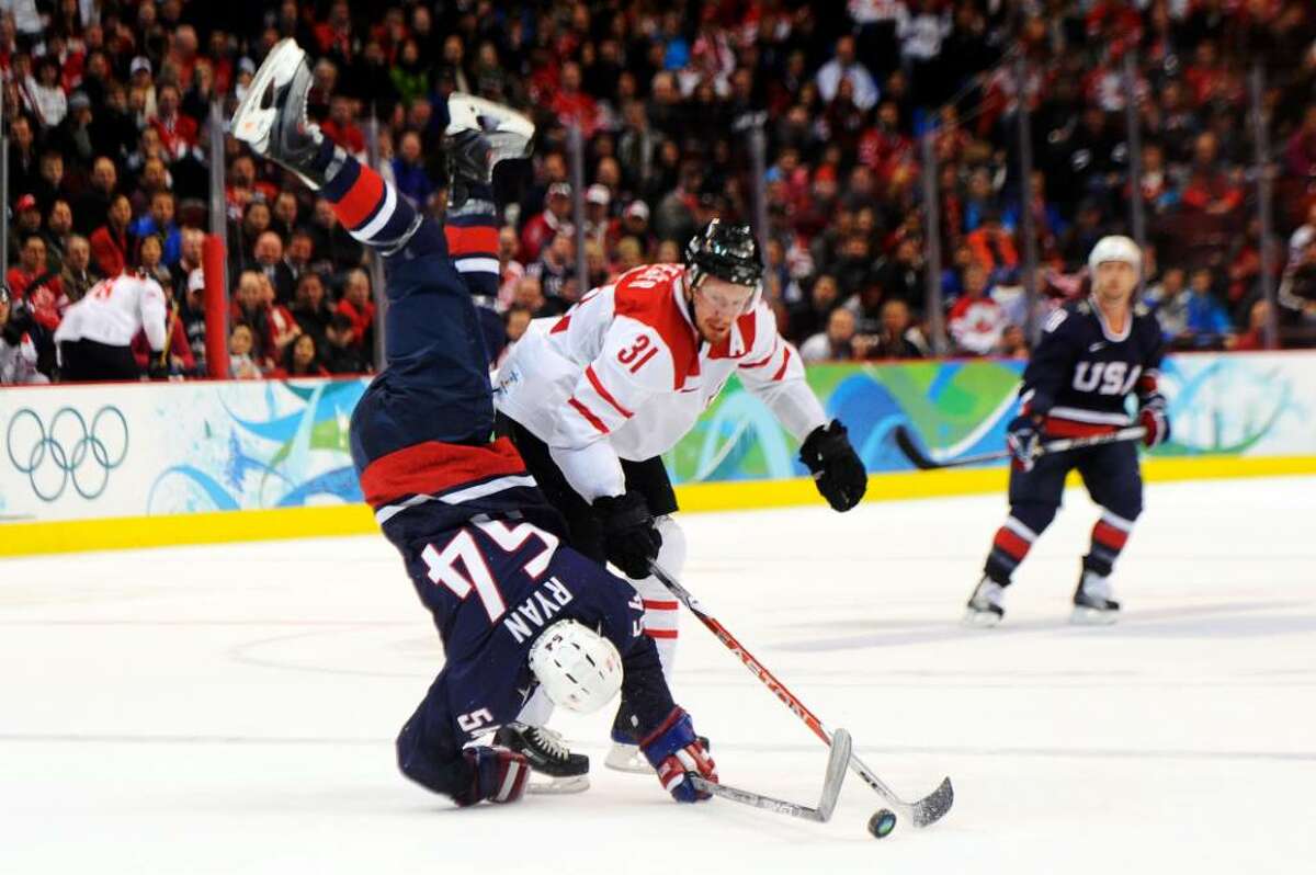 VANCOUVER, BC - FEBRUARY 24: Bobby Ryan #54 of the United States gets upended by Mathias Seger #31 of Switzerland during the ice hockey men's quarter final game between USA and Switzerland on day 13 of the Vancouver 2010 Winter Olympics at Canada Hockey Place on February 24, 2010 in Vancouver, Canada. (Photo by Kevork Djansezian/Getty Images) *** Local Caption *** Bobby Ryan;Mathias Seger