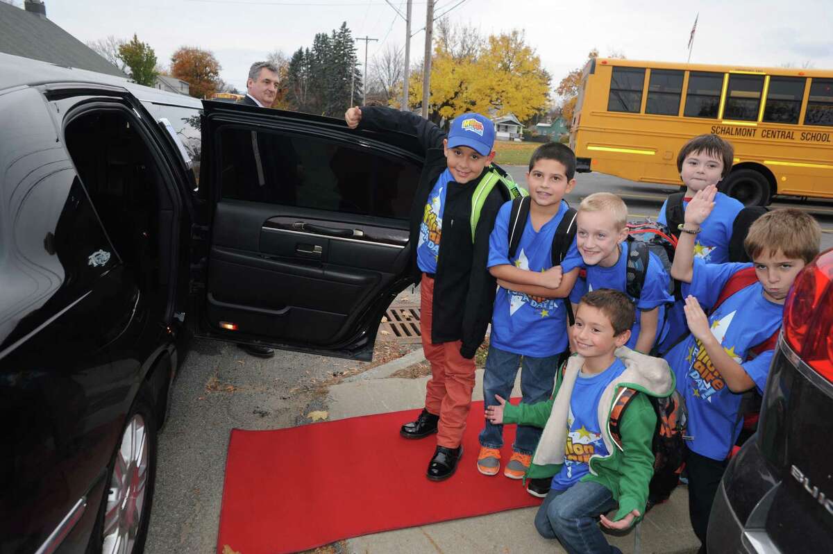 Nikos Johnson, far left, a third grade student at Jefferson Elementary School gets picked up from school by limo with five of his friends after winning the First New York Federal Credit Union's Millionaire for the Day on Thursday Nov. 13, 2014 in Rotterdam, N.Y. First New York Federal Credit Union has been teaching thousands of area students for years to save their money through its KID$ (Keep Investing Dollars Savings) Program. To celebrate the studentsa success, the credit union randomly selected a school banker to be treated like a Millionaire. As the Millionaire for the Day, Nikos Johnson and his classmates will be treated to a waiter-served lunch. In addition, Nikos and five of his friends will be picked up from Jefferson Elementary School at dismissal time and the red carpet will be rolled out treating them to a limousine ride to First New York Federal Credit Unionas headquarters at 2 Wall Street, Albany where they will meet the President/CEO, Lucy Halstead and members of the Board of Directors, receive a personal tour of the credit union and return home via limousine at the end of the day. Mr. Joby Gifford, Principal at Jefferson Elementary School. Nikos, like many other students at Jefferson Elementary School make deposits each week from money they have earned by doing chores, receiving allowance and birthday money. Some students deposit money into their savings account from the soda bottles they help return, while others often find money on the ground. (Michael P. Farrell/Times Union)