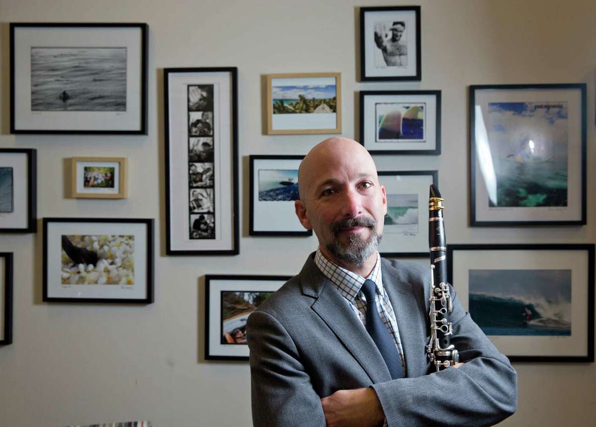 Richie Hawley teaches clarinet in the Shepherd School of Music at Rice University. A prodigy on the clarinet, he became the Cincinnati Symphony's first-chair clarinetist at age 24 (in 1994). He began teaching at Rice in 2011. He performs in a concert at Rice on Nov. 19. Hawley also is a photographer on the side, with professional experience as a surfing photographer. Here Hawley poses with his clarinet and some of his surfing photos on Tuesday, November 11, 2014 at Rice University in Houston, TX. (PhotoFor the Chronicle by Thomas B. Shea)