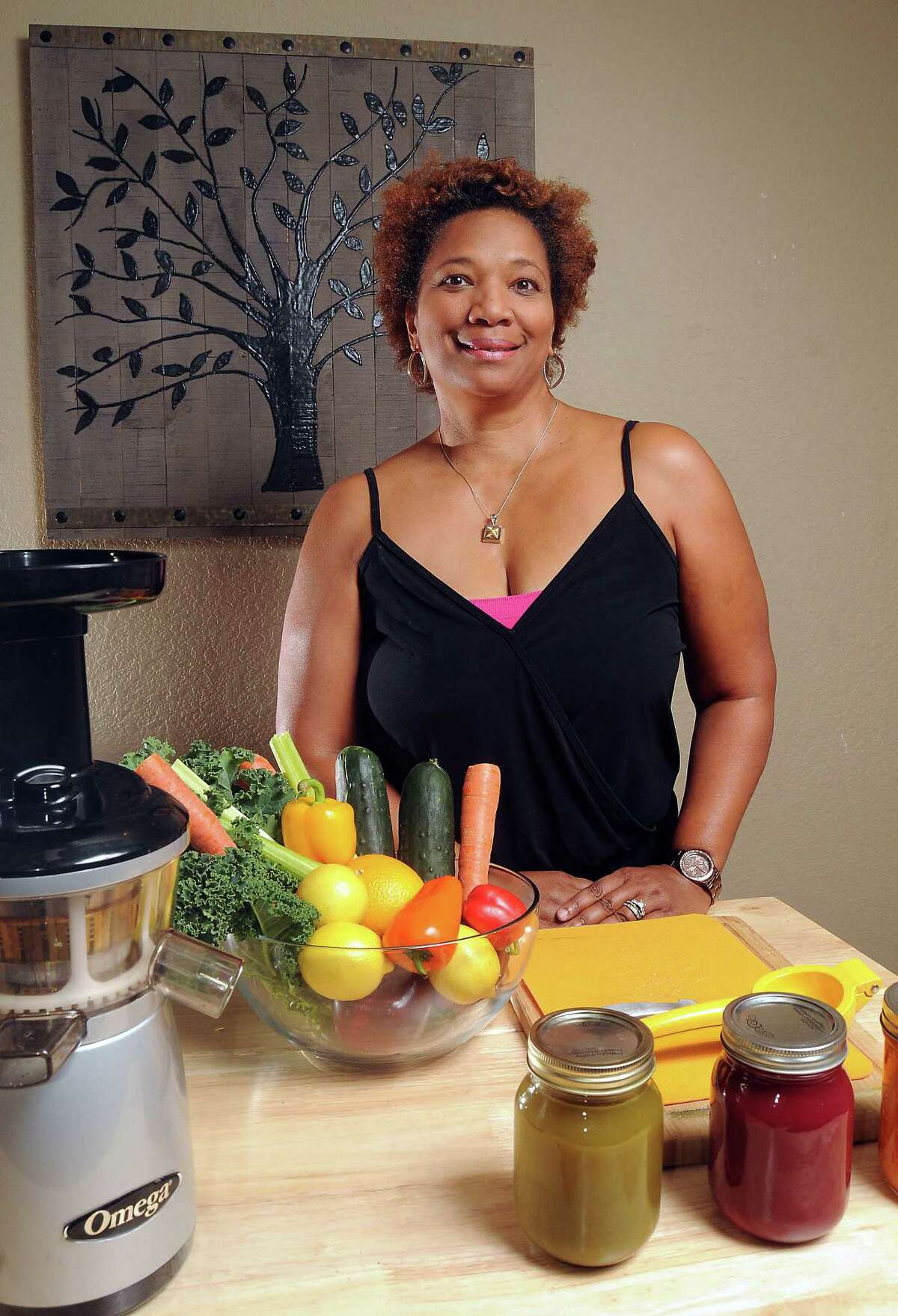 Pam Ennis with the ingredients for making a detox drink at YLive Juice Bar on Spring Cypress Rd Thursday Oct 23, 2014.(Dave Rossman photo)