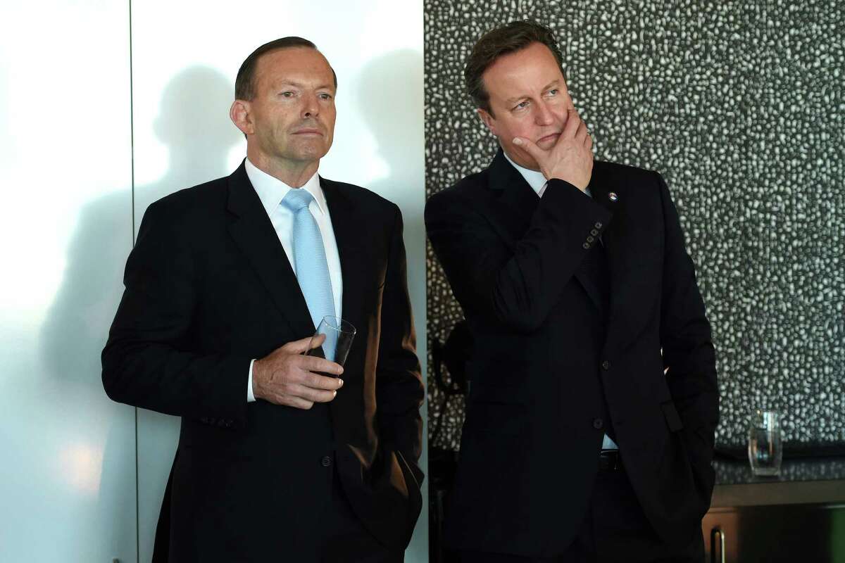 Australian Prime Minister Tony Abbott, left, stands with British Prime Minister David Cameron as they wait to speak at an infrastructure business breakfast in Sydney,Australia, Friday, Nov. 14, 2014. Prime Minister Cameron is in Australia to attend the G-20 conference in Brisbane. (AAP Image/Dan Himbrechts,Pool)