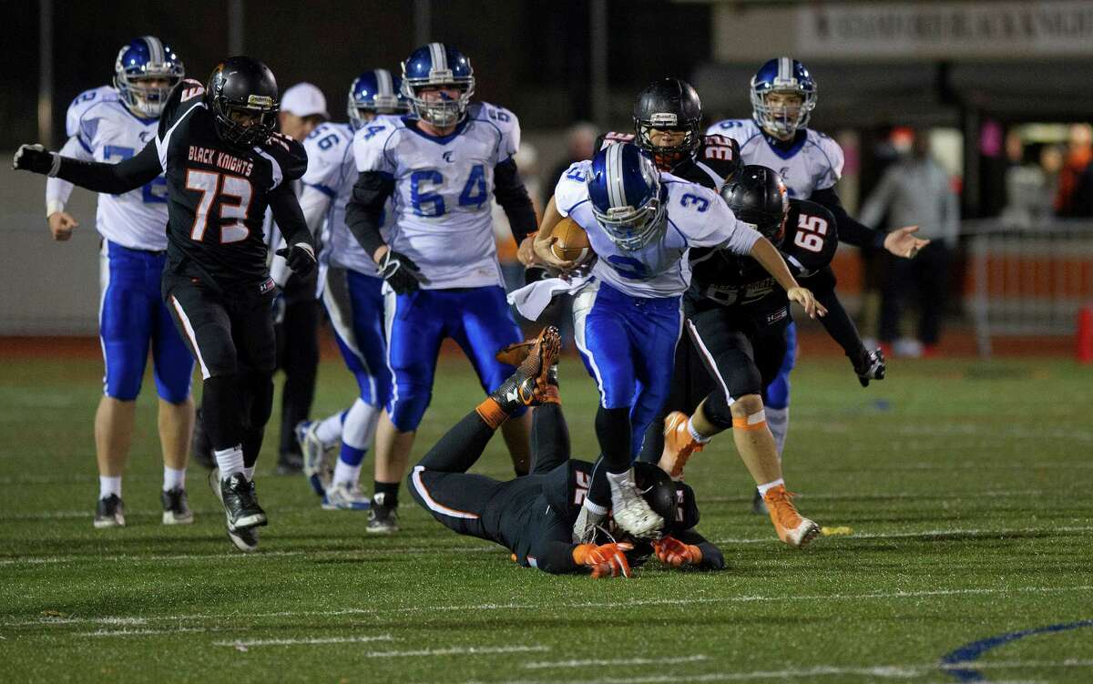 Fairfield Ludlowe's Bryan Pacewicz carries the ball during Friday's football game at Stamford High School on November 14, 2014.