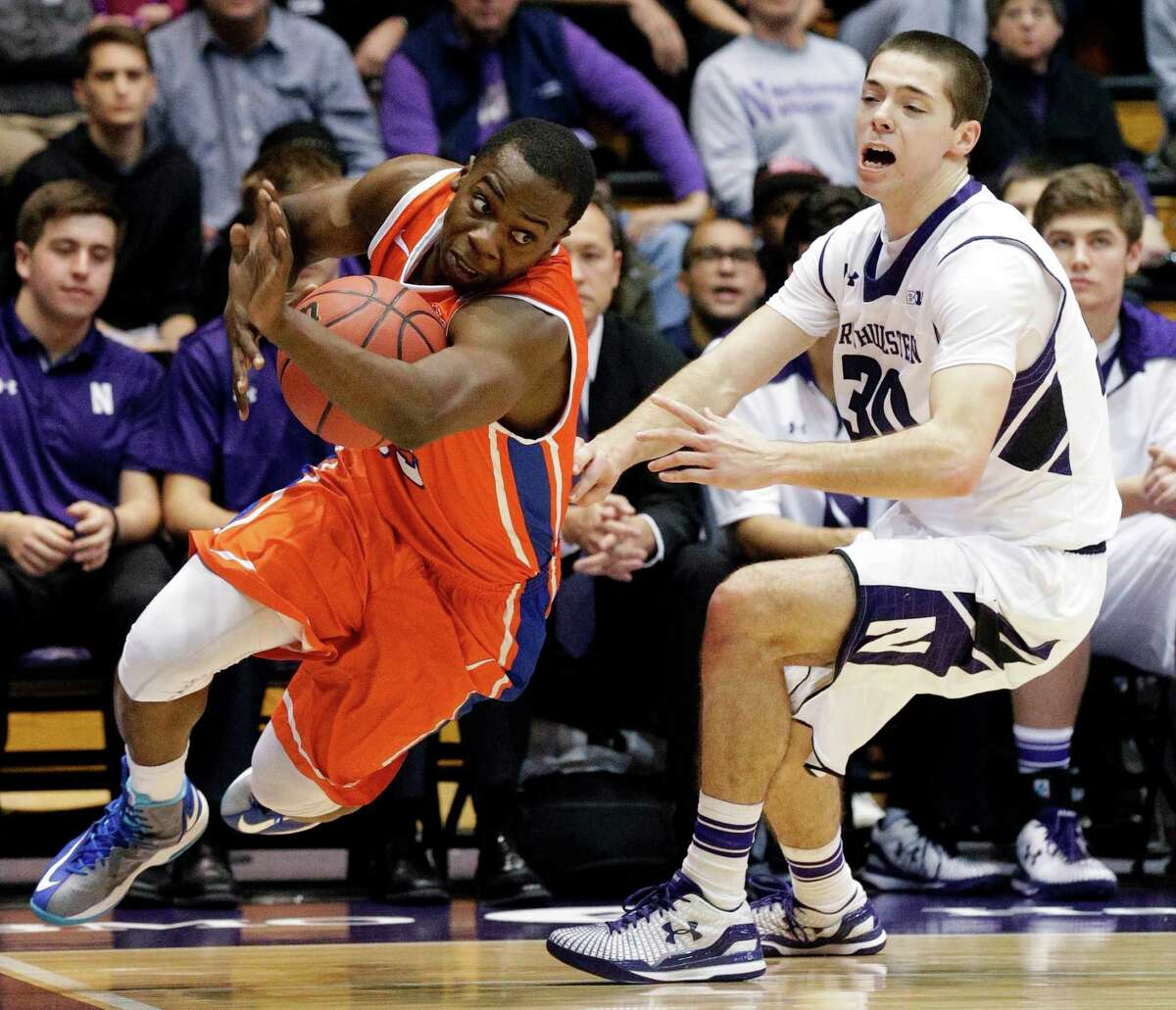 Houston Baptist guard Anthony Odunsi, left, tries to maneuver past Northwestern forward Bryant Mclintosh during the first half of Friday's game.