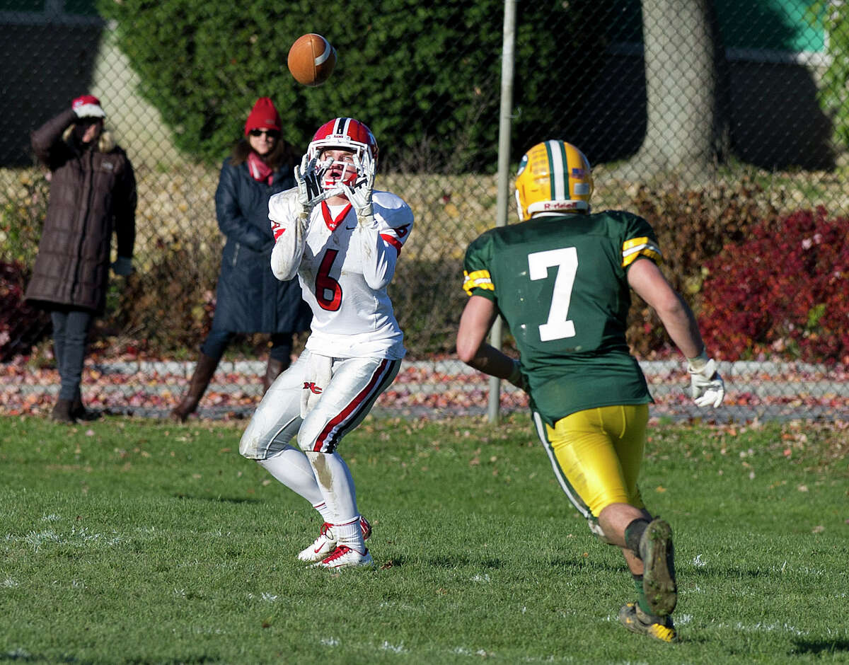New Cannan's Michael Kraus makes a catch for a touchdown during Saturday's football game at Trinity Catholic High School on November 15, 2014.