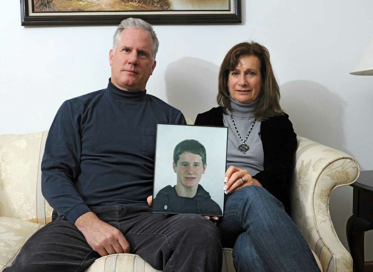 Kevin & Diane Flood, whose son, Dan, 24, has battled heroin addiction for more than 6 years and has been homeless in Albany for several months, hold a photo of him at their home on Thursday, Nov. 6, 2014 in Albany, N.Y. (Lori Van Buren / Times Union)