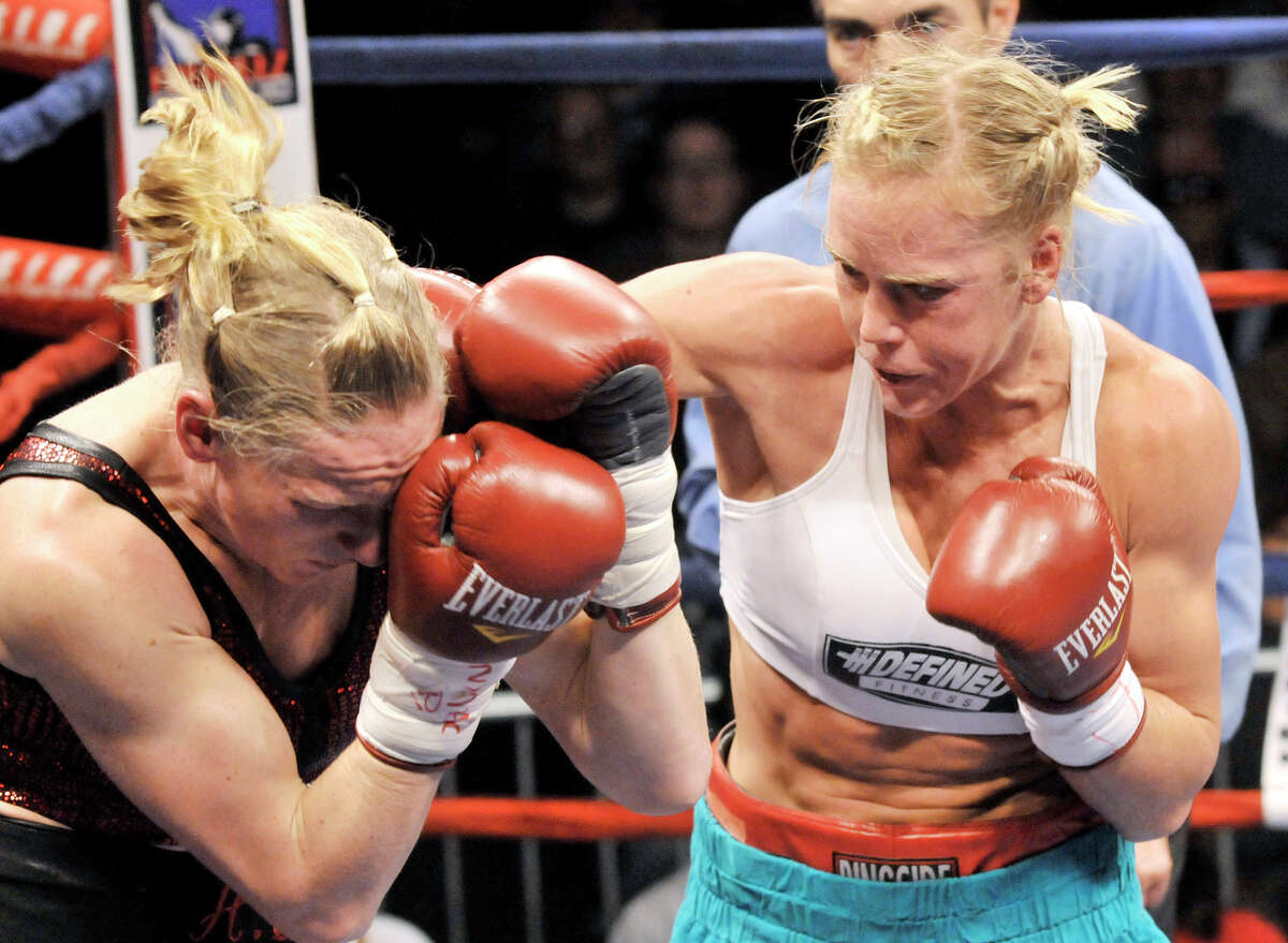 Holly Holm, the world's former No. 1-rated female boxer, has pulled out of her much-anticipated Ultimate Fighting Championship debut. Promoter Lenny Fresquez told the Albuquerque Journal Thursday, Nov. 13, 2014, that Holm suffered a neck injury in training and had to withdraw from her scheduled fight with Colorado native Raquel Pennington on Dec. 6 in Las Vegas. In this Dec. 2, 2011, file photo, Holly Holm, right, lands a punch against Anne Sophie Mathis, of France, during an IBA and WBAN welterweight title fight in Laguna, N.M.
