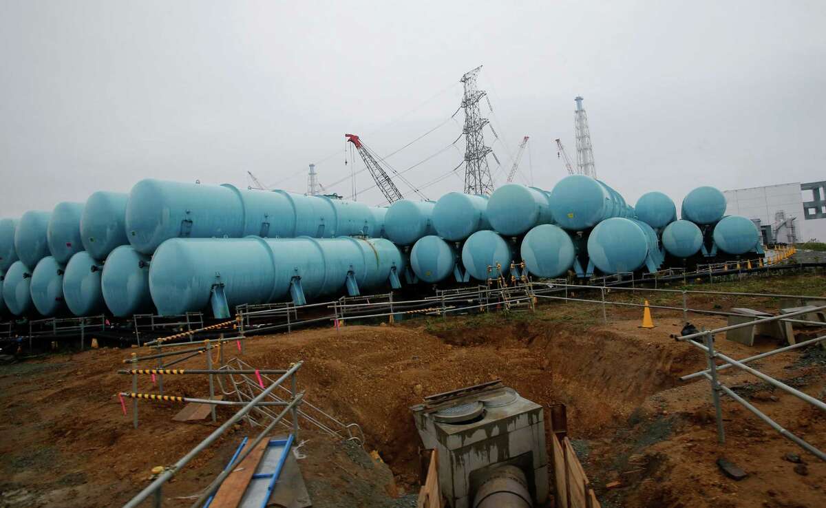 Water tanks that store contaminated water are seen at the Fukushima Dai-ichi nuclear power plant in Okuma, Fukushima prefecture, northeastern Japan, Wednesday, Nov. 12, 2014. Nearly all the workers at the Fukushima Dai-ichi plant are devoted to a single, enormously distracting problem: coping with a still-growing amount of contaminated water that has been used to keep the damaged reactors from overheating, and whose volumes are swelled by groundwater that is getting into the reactor buildings. A number of buildings housing water treatment machines and hundreds of huge blue- and gray-colored industrial tanks to store the excess water are rapidly taking over the plant, which saw three of its six reactors melt down following the 2011 earthquake and tsunami.