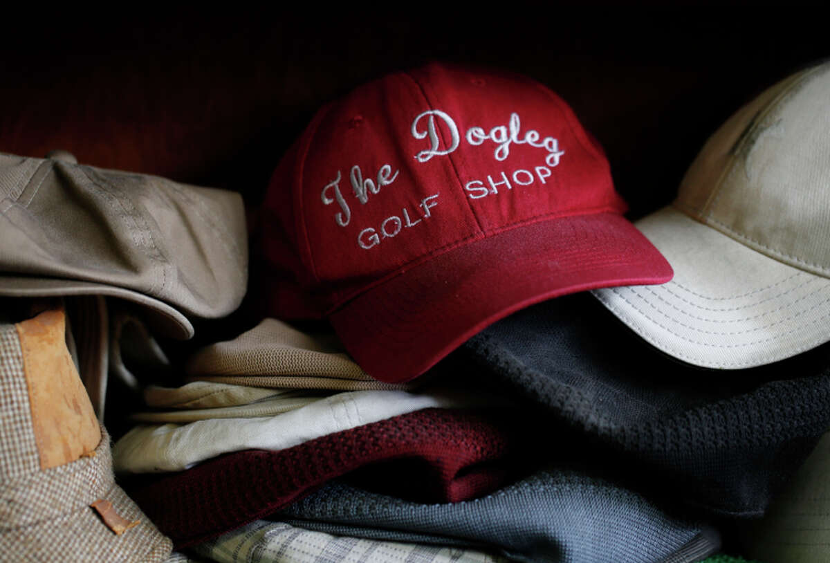 A collection of hats sits on one of the shelves at Glenn’s shop, which has a clubhouse atmosphere.