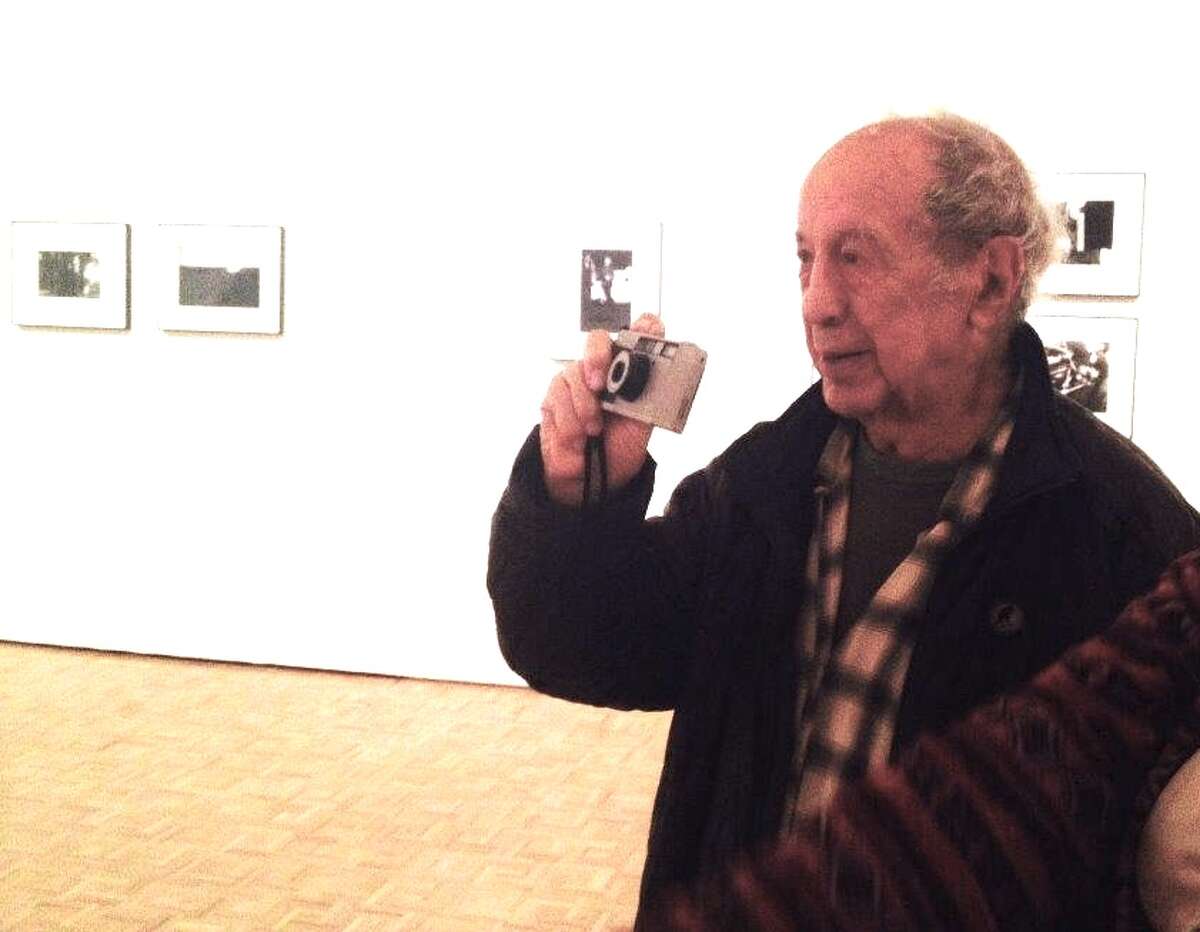 Robert Frank walks around gallery, snaps photos of his own photos