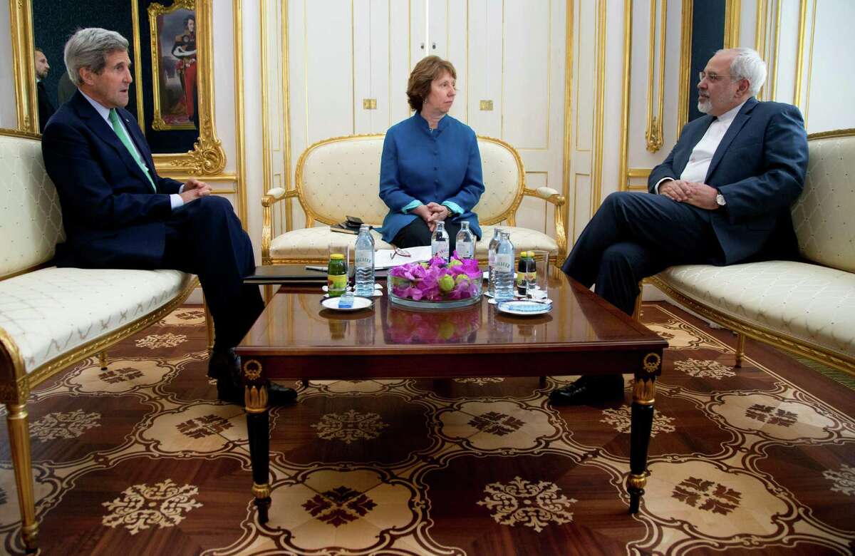In this Wednesday, Oct. 15, 2014, file photo, from left, U.S. Secretary of State John Kerry, European Union High Representative Catherine Ashton, and Iranian Foreign Minister Mohammad Javad Zarif are photographed as they participate in a trilateral meeting in Vienna, Austria. Iran and six world powers are closer than ever to a deal that would crimp Tehranâs ability to make nuclear arms - a status that would lead to a progressive end to sanctions on the Islamic Republic and ease tensions that could boil over into a new Middle East war. The bad news? Substantial differences remain. (AP Photo/Carolyn Kaster, Pool, File)