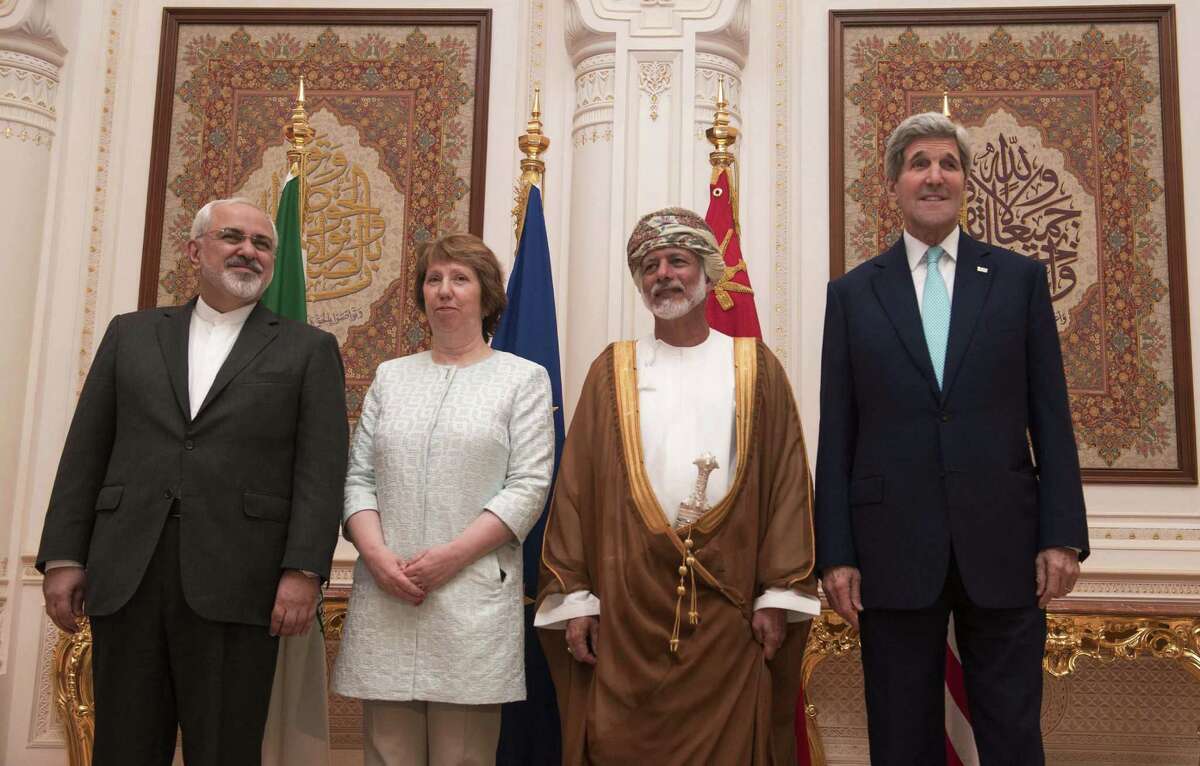 In this Sunday, Nov. 9, 2014, file photo, posing for a photo are, from left, Iranian Foreign Minister Javad Zarif, European Union adviser Catherine Ashton, Omani Minister Responsible for Foreign Affairs Yussef bin Alawi and US Secretary of State John Kerry, in Muscat. Iran and six world powers are closer than ever to a deal that would crimp Tehranâs ability to make nuclear arms - a status that would lead to a progressive end to sanctions on the Islamic Republic and ease tensions that could boil over into a new Middle East war. The bad news? Substantial differences remain. (AP PHOTO/NICHOLAS KAMM, POOL)