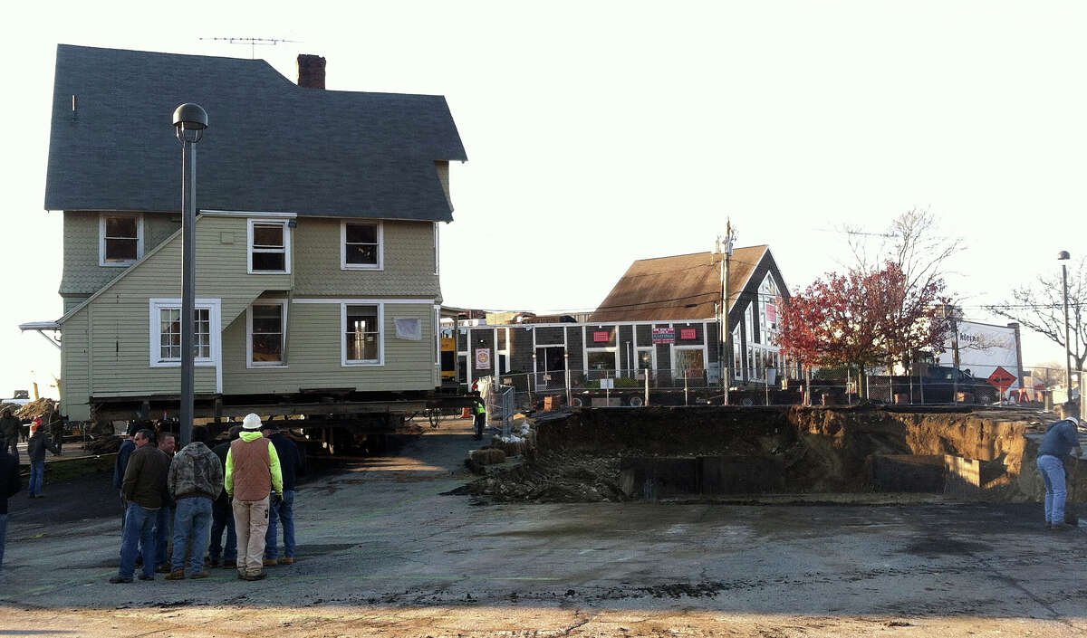 The Kemper-Gunn House is poised next to its new foundation in the Baldwin parking lot, after its move across Elm Street early Tuesday.